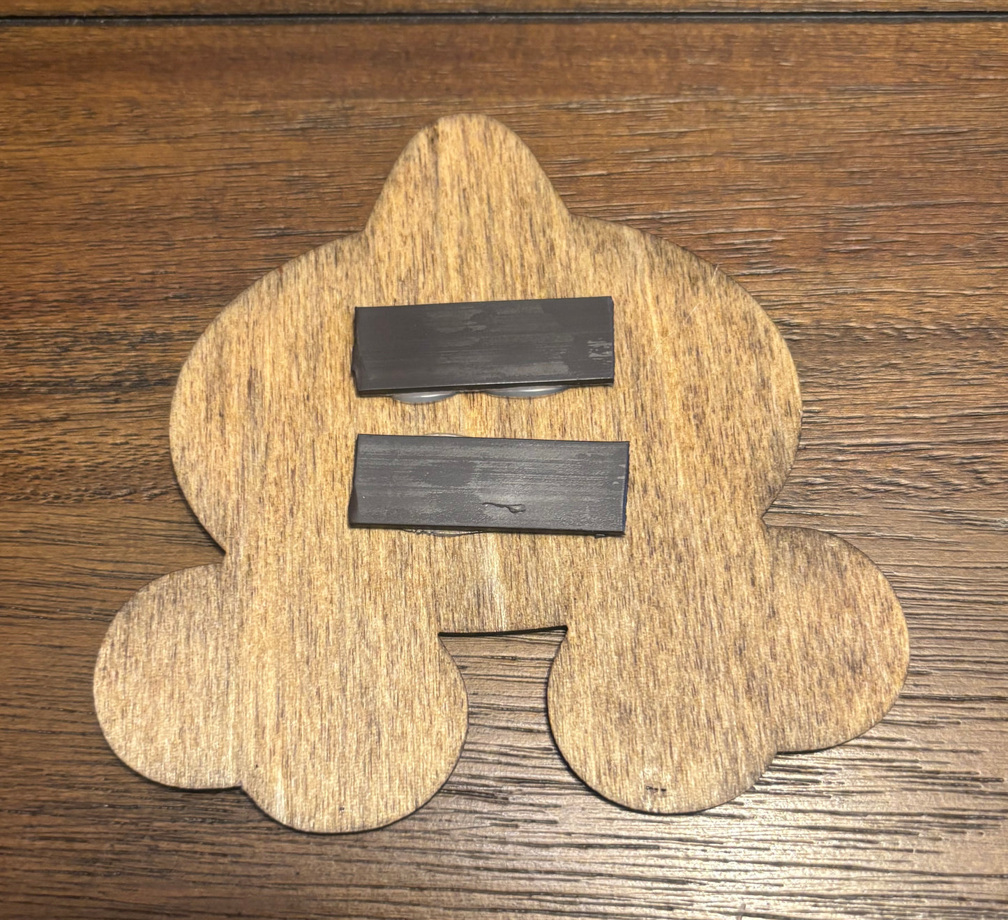 Stained basswood fridge magnet of a the Team Aqua logo from the Pokemon video games