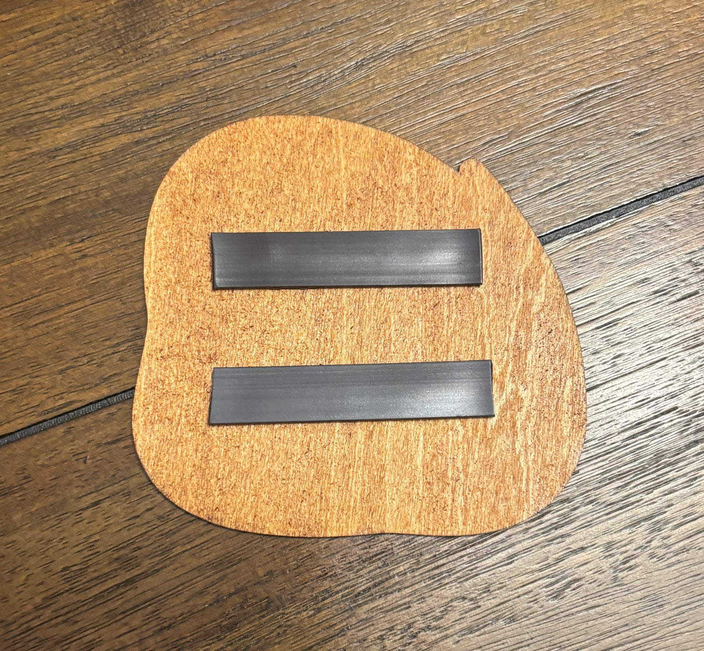 Stained basswood fridge magnet of a the Team Skull logo from the Pokemon video games