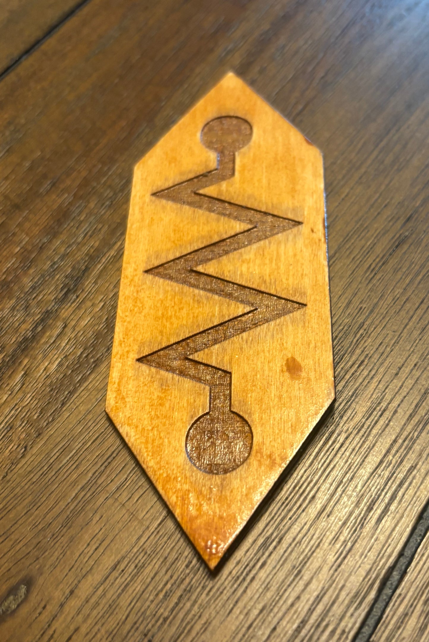Stained basswood fridge magnet of the Church of Robotology logo from Futurama