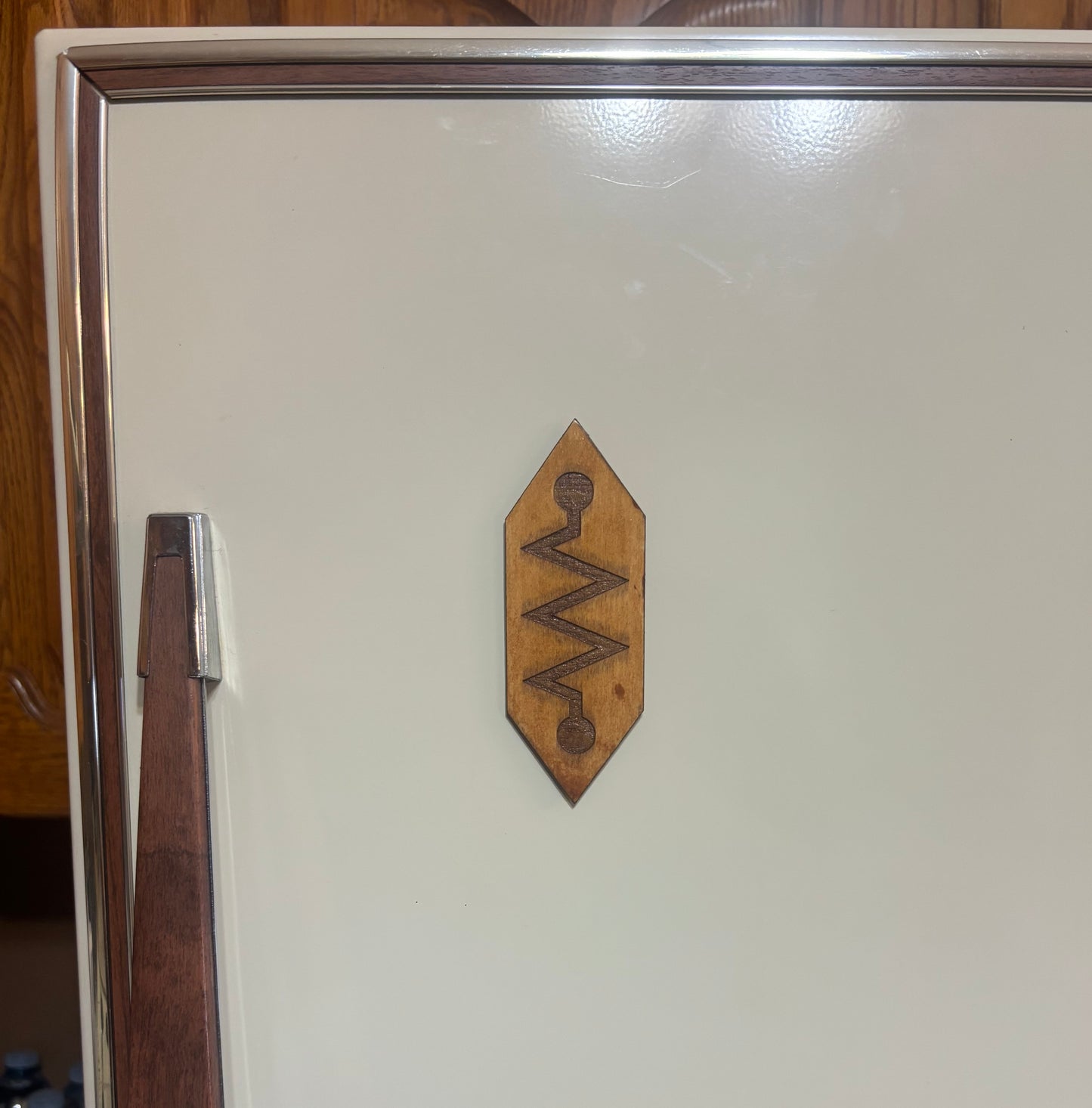 Stained basswood fridge magnet of the Church of Robotology logo from Futurama