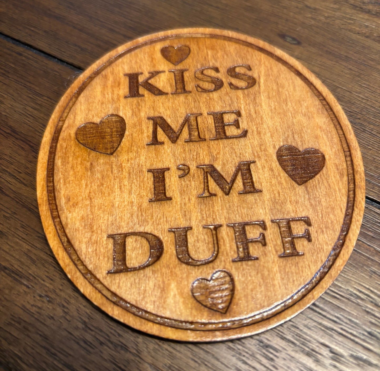 Stained basswood fridge magnet of the Kiss me I'm Duff sticker from the Simpsons
