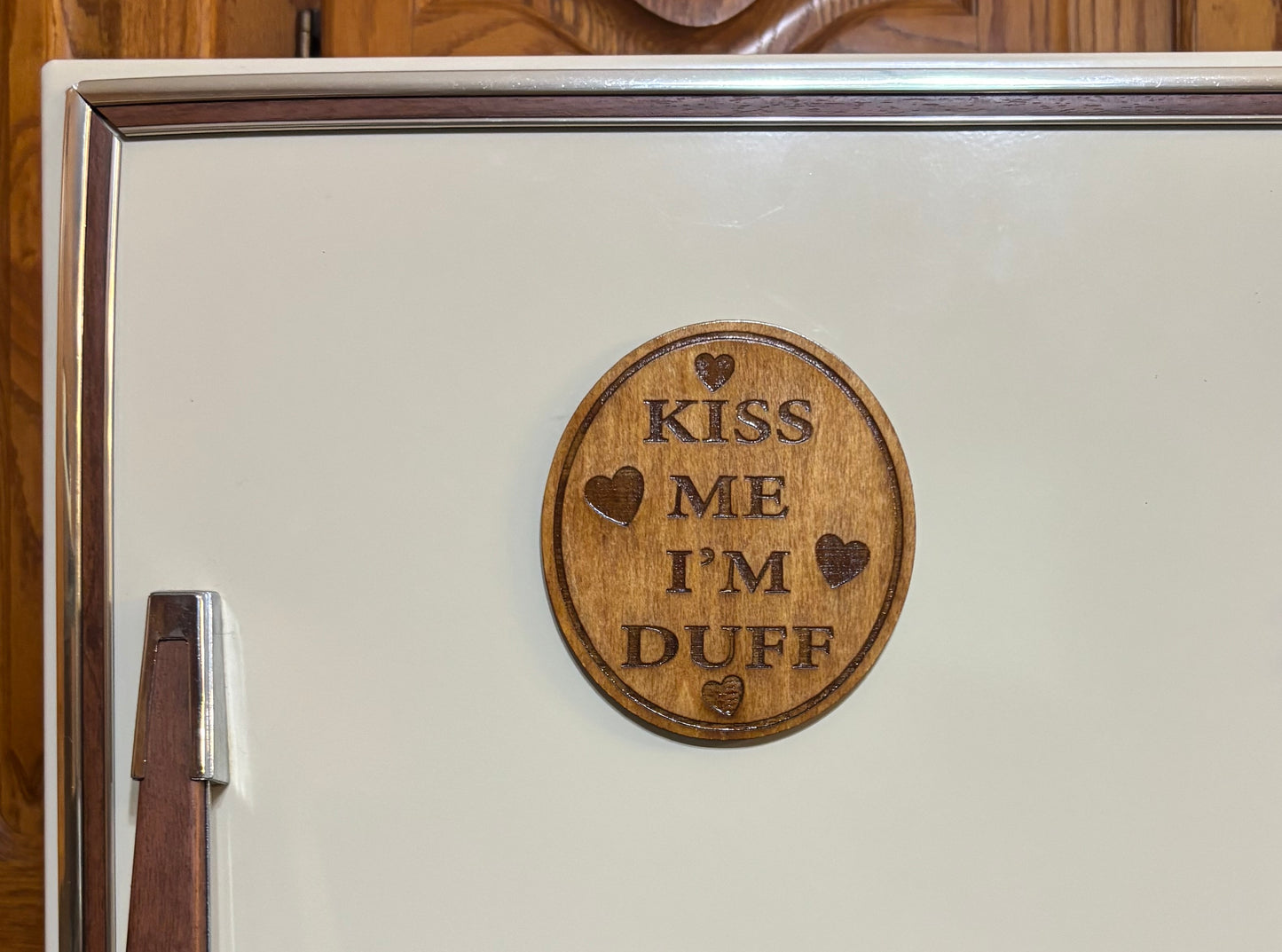 Stained basswood fridge magnet of the Kiss me I'm Duff sticker from the Simpsons