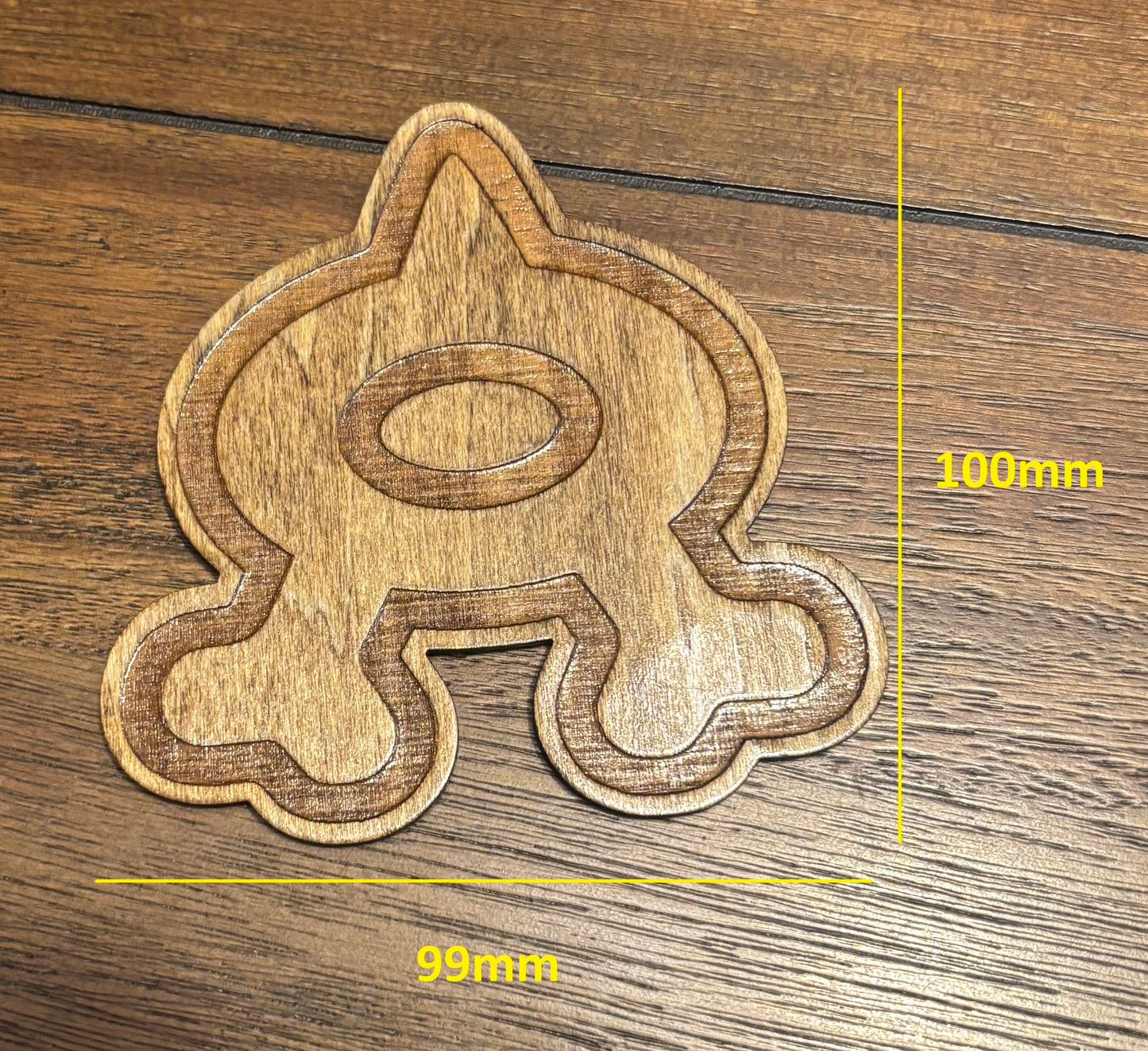 Stained basswood fridge magnet of a the Team Aqua logo from the Pokemon video games