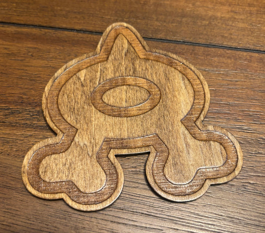 Stained basswood fridge magnet of a the Team Aqua logo from the Pokemon video games