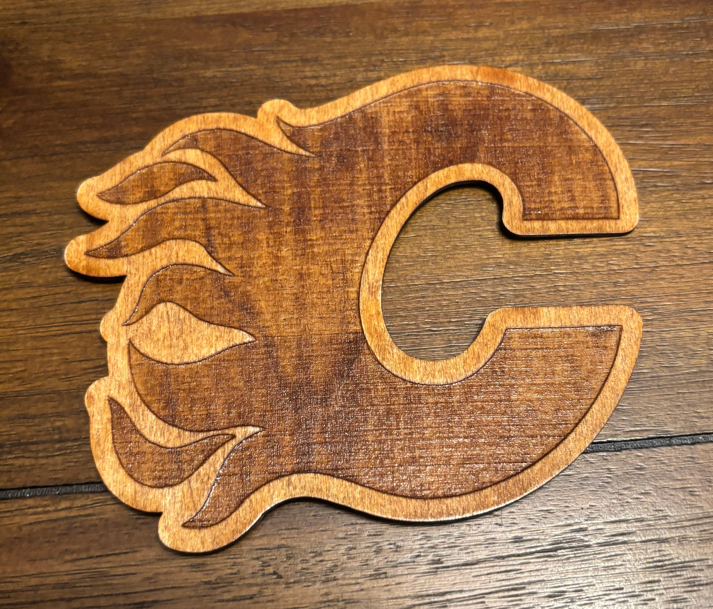 Stained basswood fridge magnet of the Calgary Flames hockey team logo