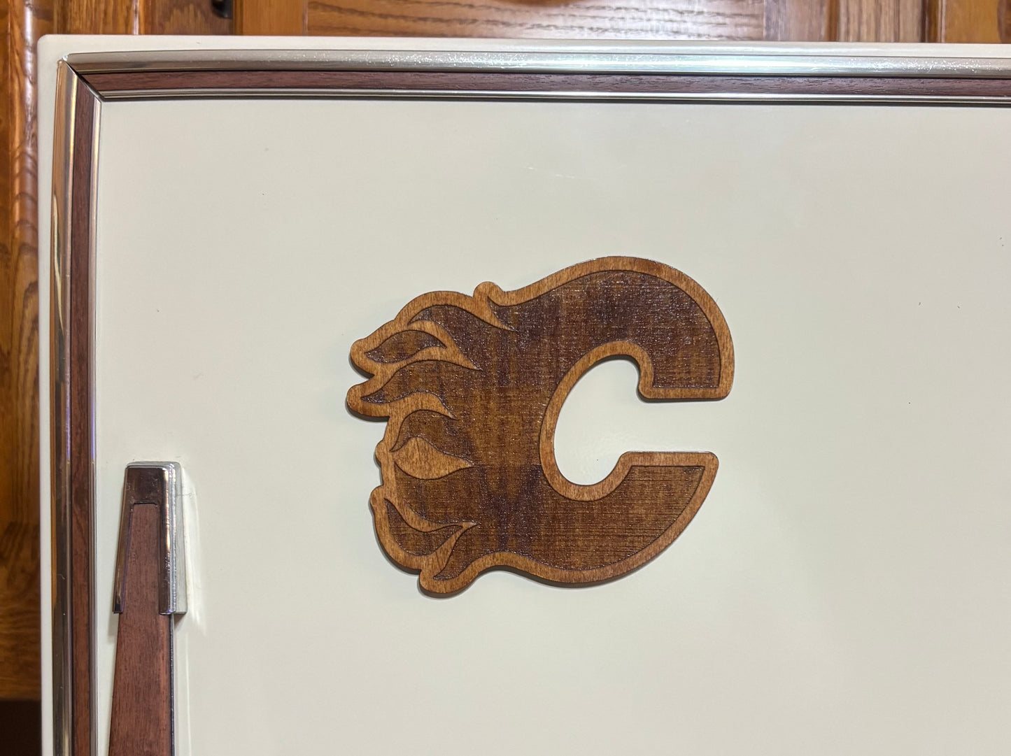 Stained basswood fridge magnet of the Calgary Flames hockey team logo