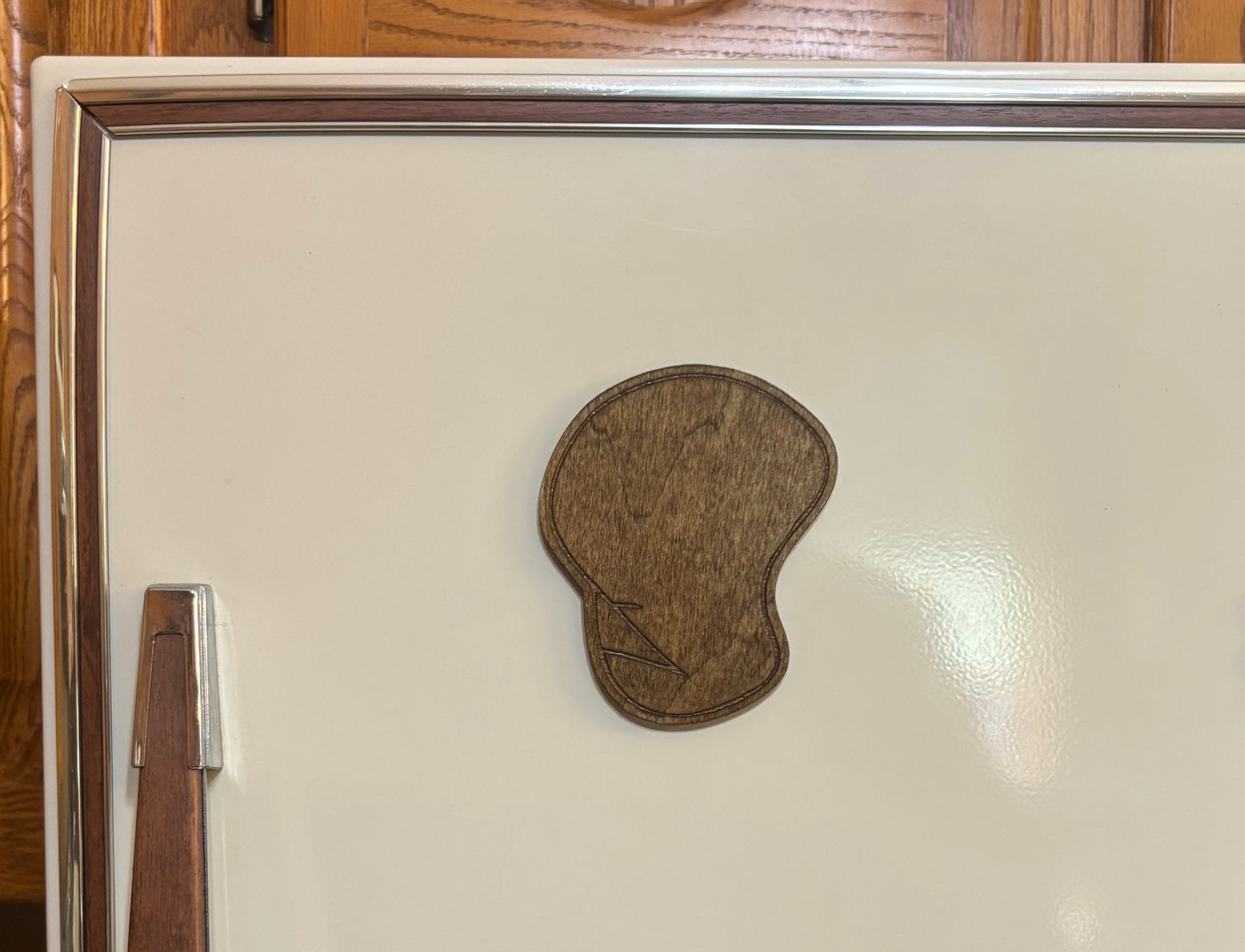 Stained basswood fridge magnet of the Dignity drawing from the Simpsons