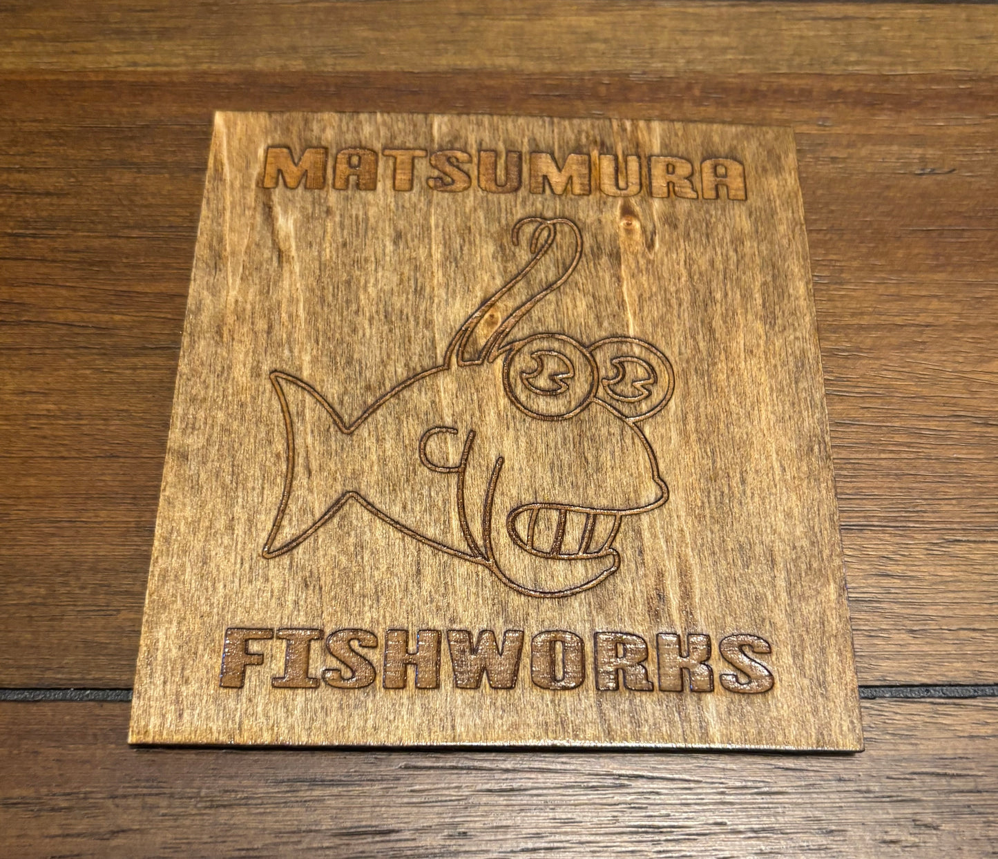 Stained basswood fridge magnet of the Matsumura logo from the Simpsons