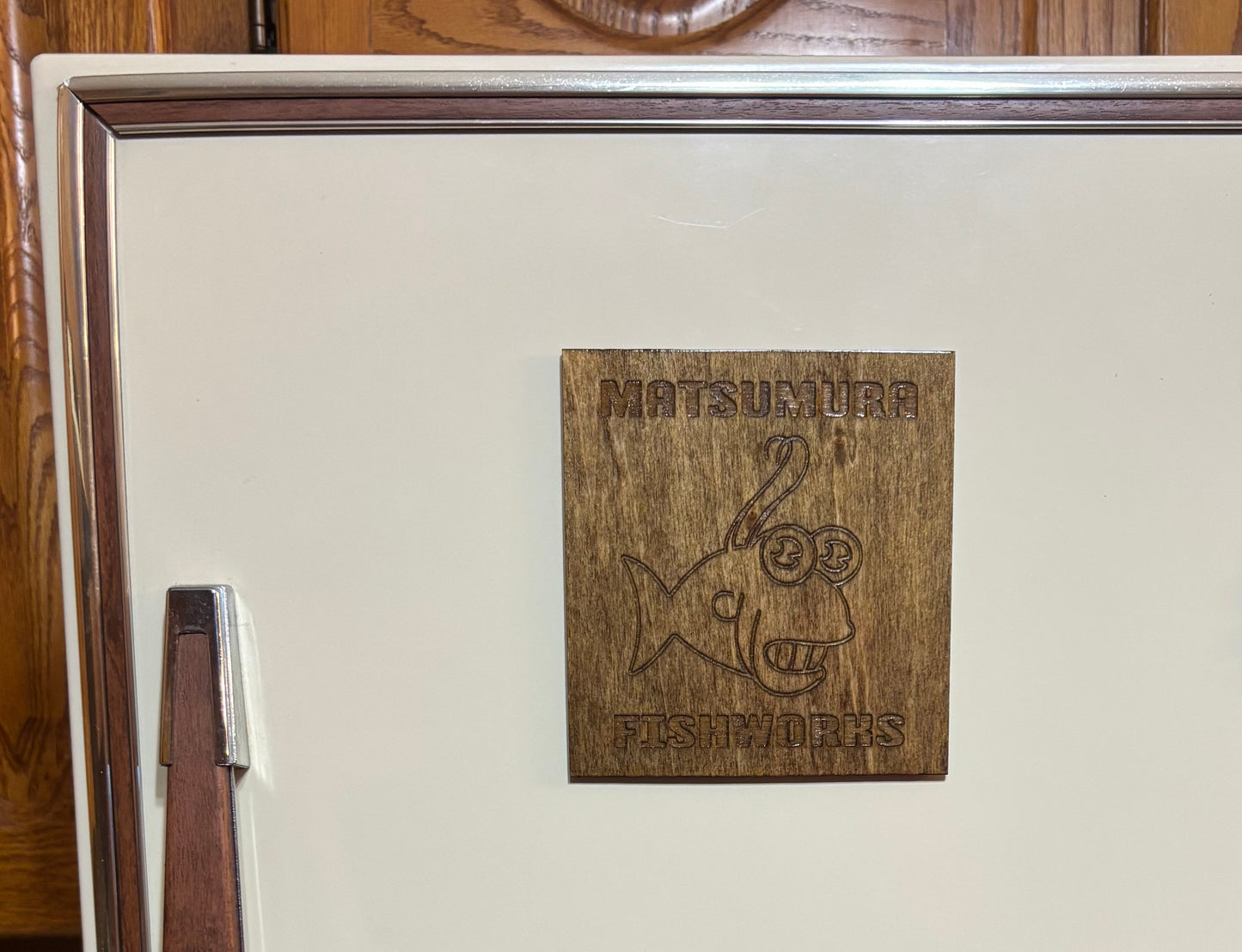 Stained basswood fridge magnet of the Matsumura logo from the Simpsons