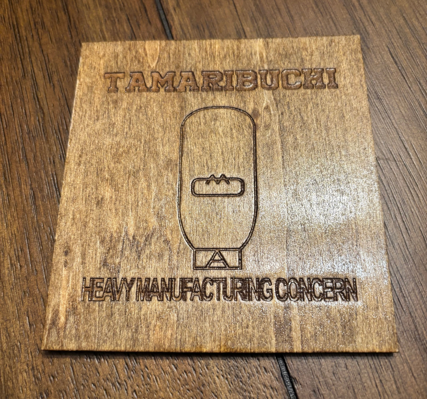 Stained basswood fridge magnet of the Tamaribuchi logo from the Simpsons