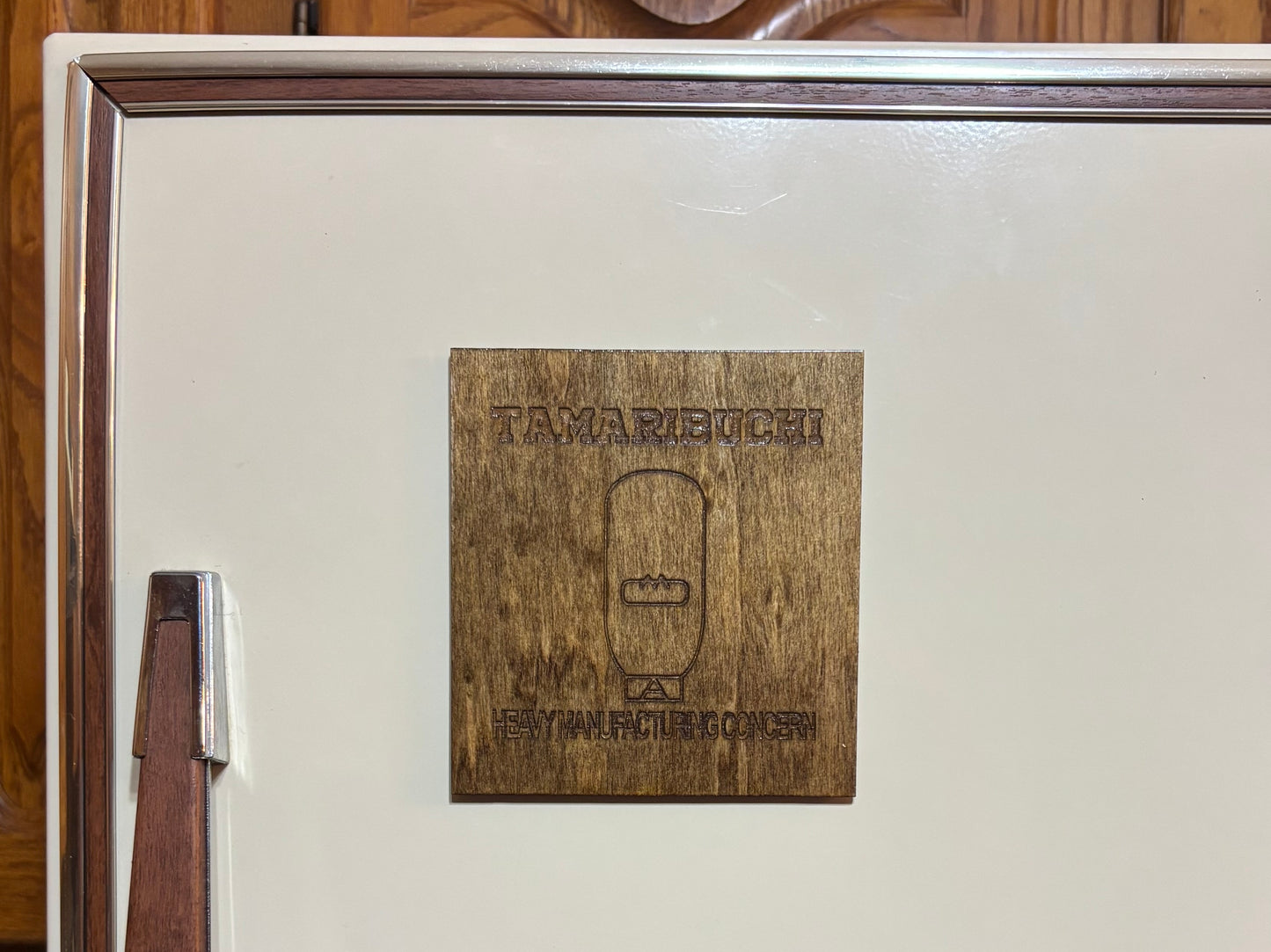 Stained basswood fridge magnet of the Tamaribuchi logo from the Simpsons