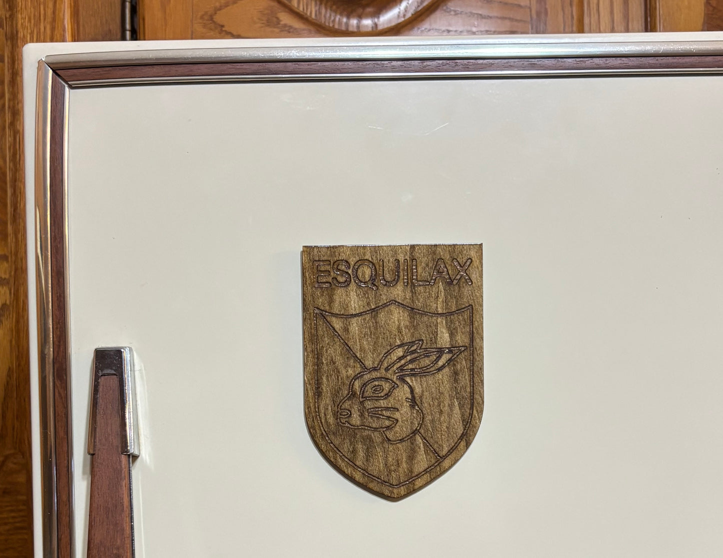 Stained basswood fridge magnet of the Esquilax banner from the Simpsons