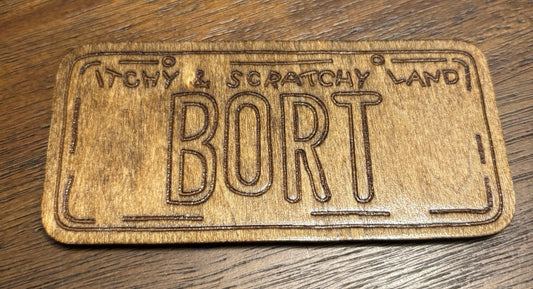 Stained basswood fridge magnet of the Bort licence plate from the Simpsons