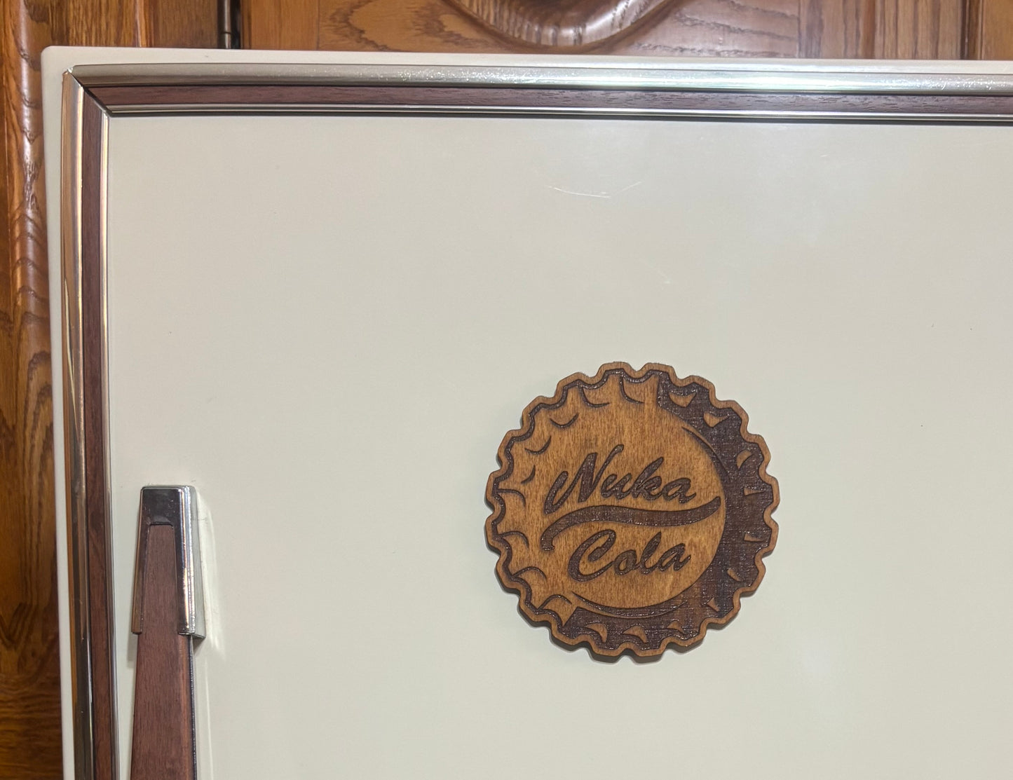 Stained basswood fridge magnet of the Nuka-Cola logo from the Fallout video games