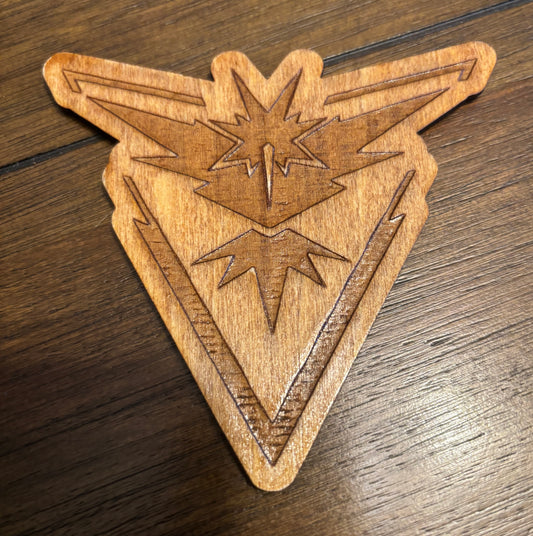 Stained basswood fridge magnet of a the Team Instinct logo from the Pokemon video games