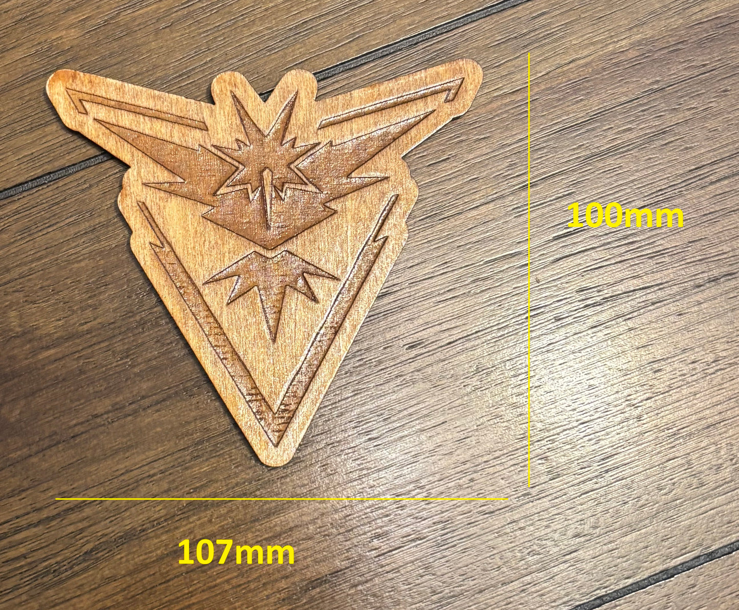 Stained basswood fridge magnet of a the Team Instinct logo from the Pokemon video games