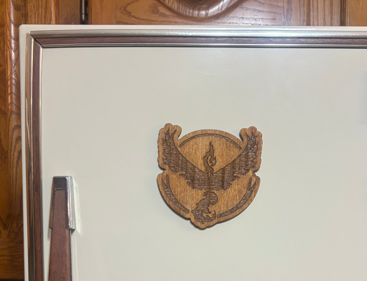 Stained basswood fridge magnet of a the Team Valor logo from the Pokemon video games