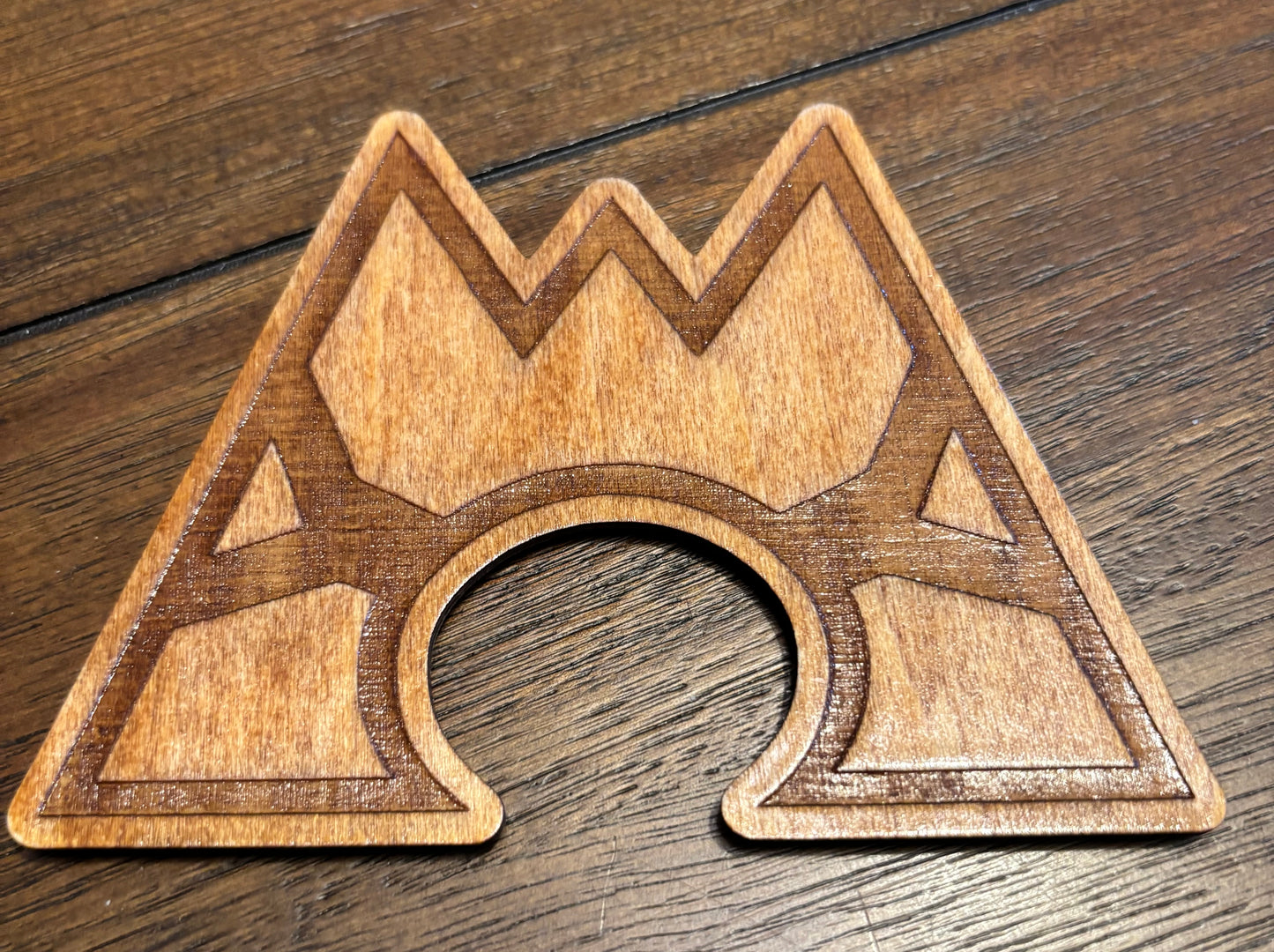 Stained basswood fridge magnet of a the Team Magma logo from the Pokemon video games