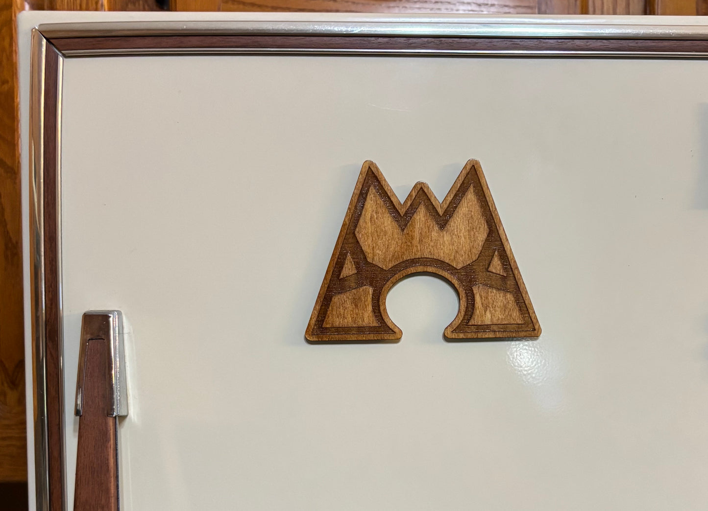 Stained basswood fridge magnet of a the Team Magma logo from the Pokemon video games