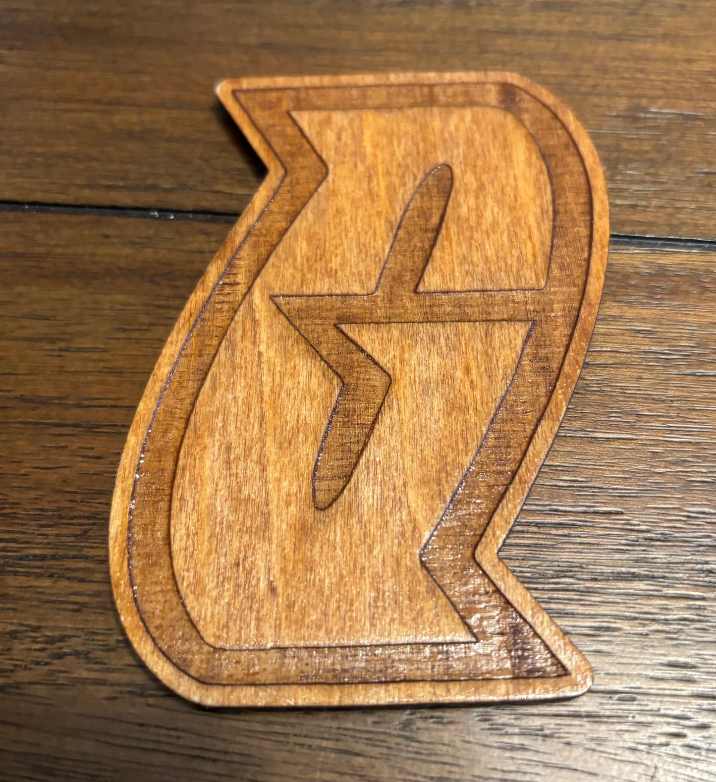 Stained basswood fridge magnet of a the Team Galactic logo from the Pokemon video games