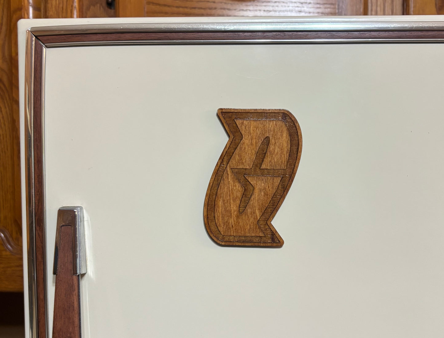 Stained basswood fridge magnet of a the Team Galactic logo from the Pokemon video games
