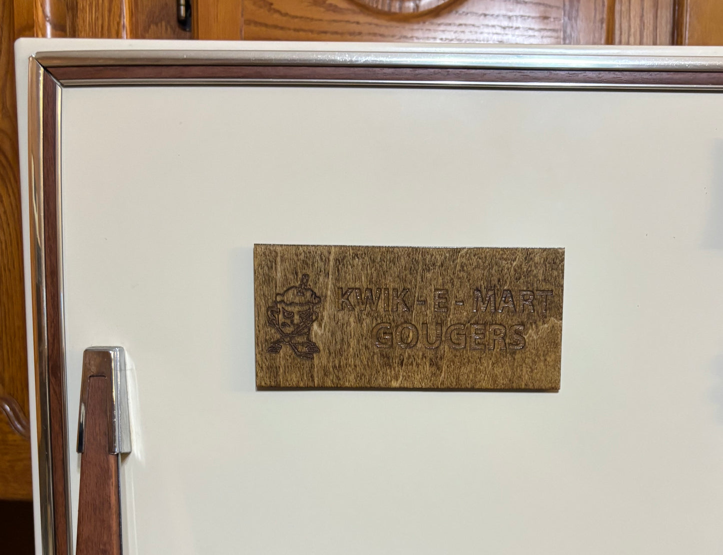 Stained basswood fridge magnet of the Kwik-E-Mart Gougers logo from the Simpsons
