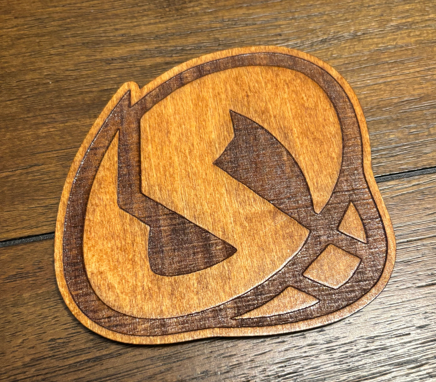 Stained basswood fridge magnet of a the Team Skull logo from the Pokemon video games