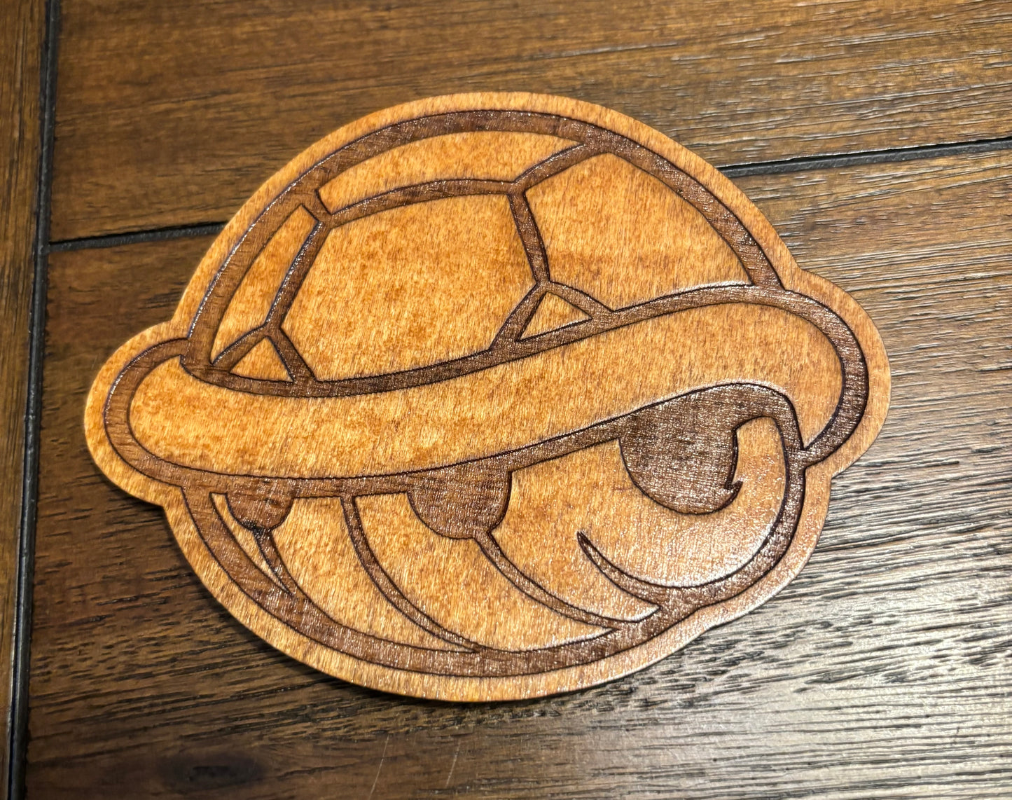 Stained basswood fridge magnet of a Turtle shell from the Mario video games