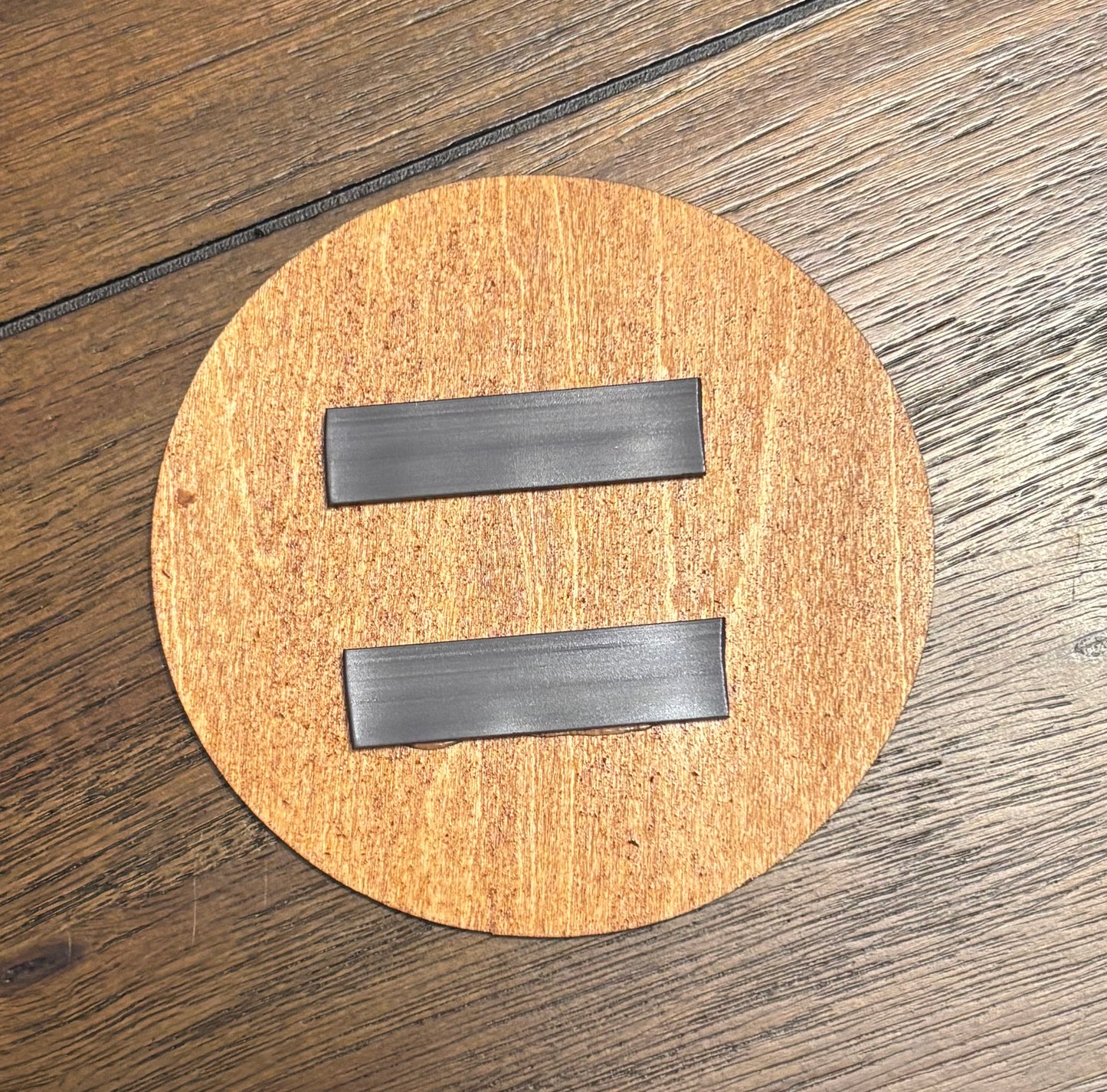 Stained basswood fridge magnet of the Aperture logo from the Portal video game