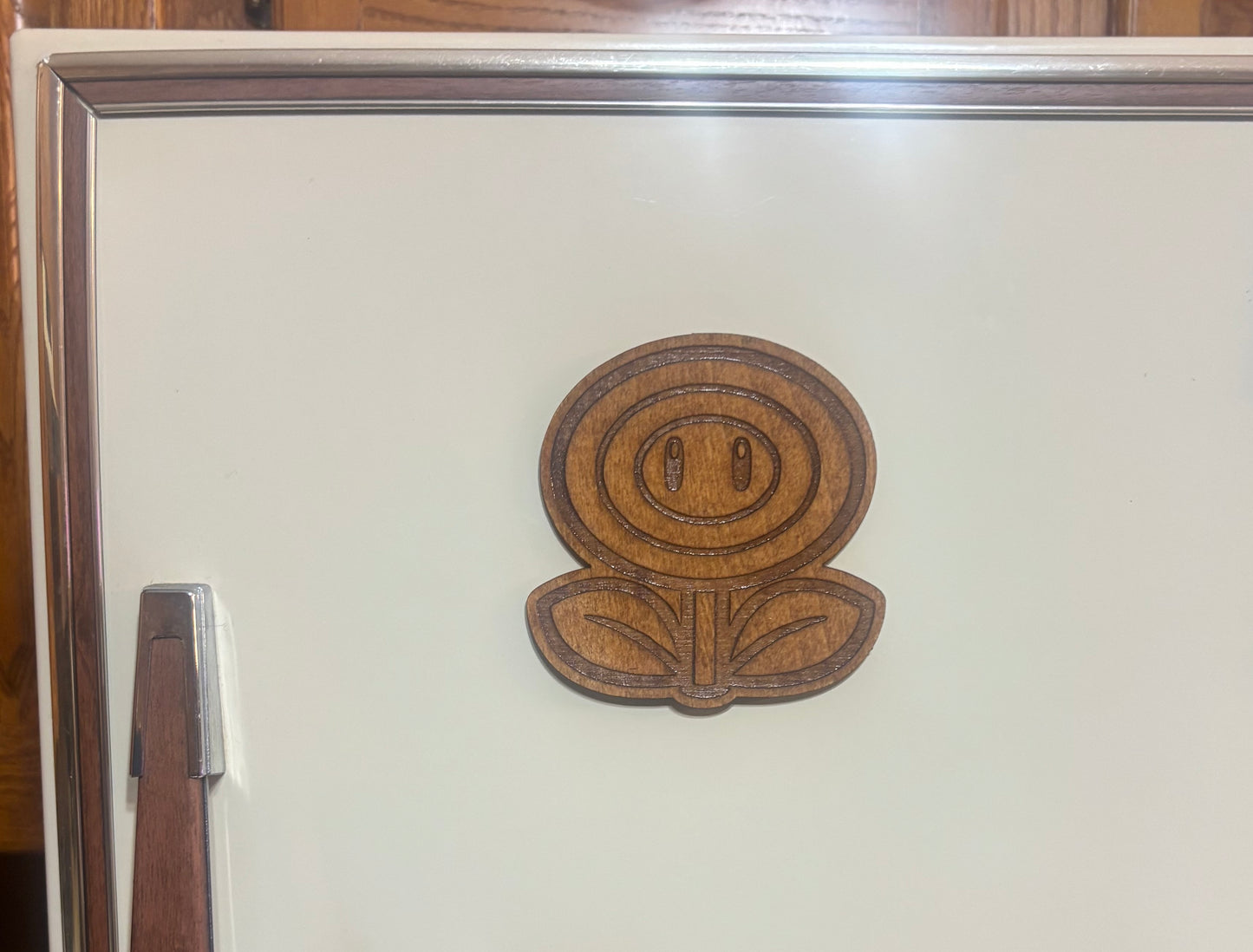 Stained basswood fridge magnet of a Flower power up from the Mario video games