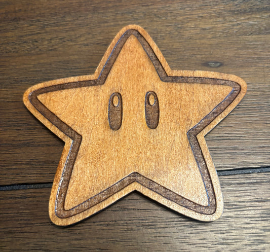 Stained basswood fridge magnet of a Super star from the Mario video games