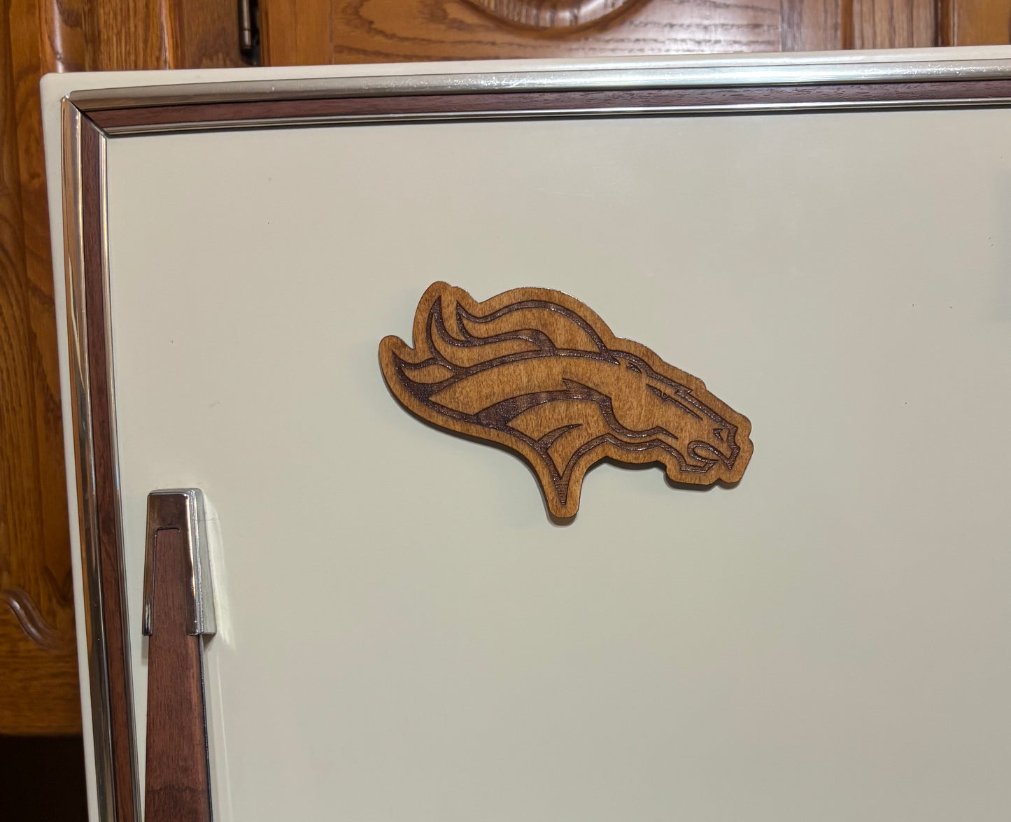 Stained basswood fridge magnet of the Denver Broncos football team logo