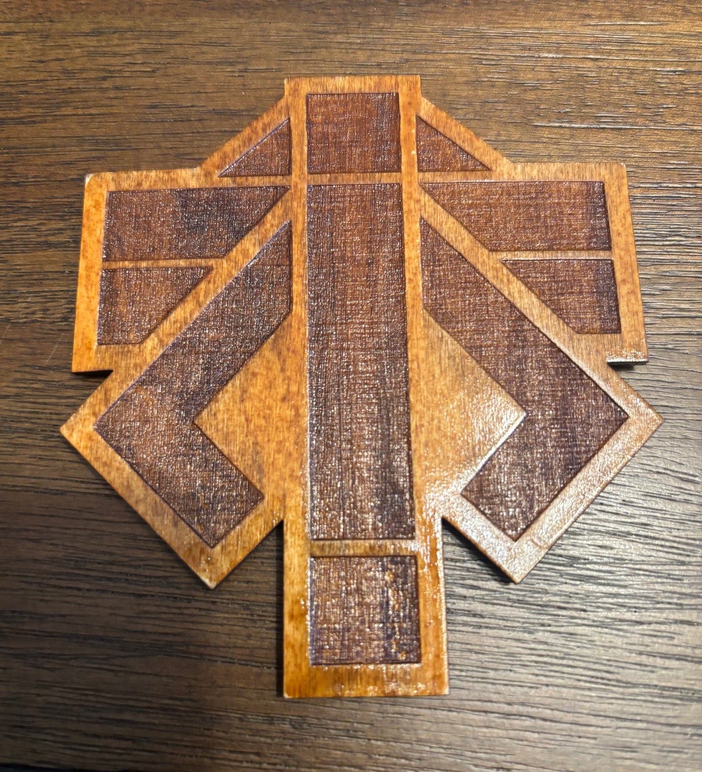 Stained basswood fridge magnet of the Advent logo from the X-COM video games