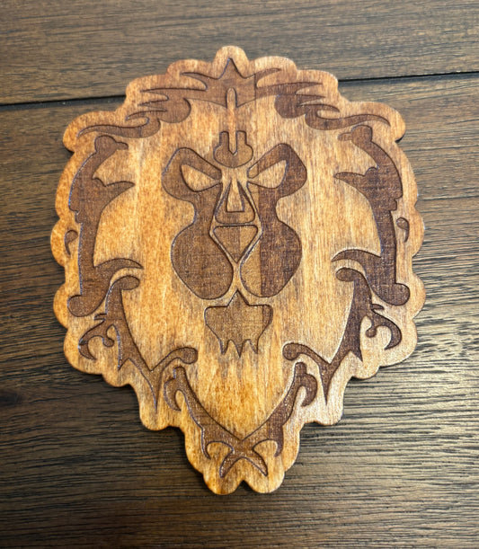 Stained basswood fridge magnet of a the Alliance symbol from the Warcraft video games