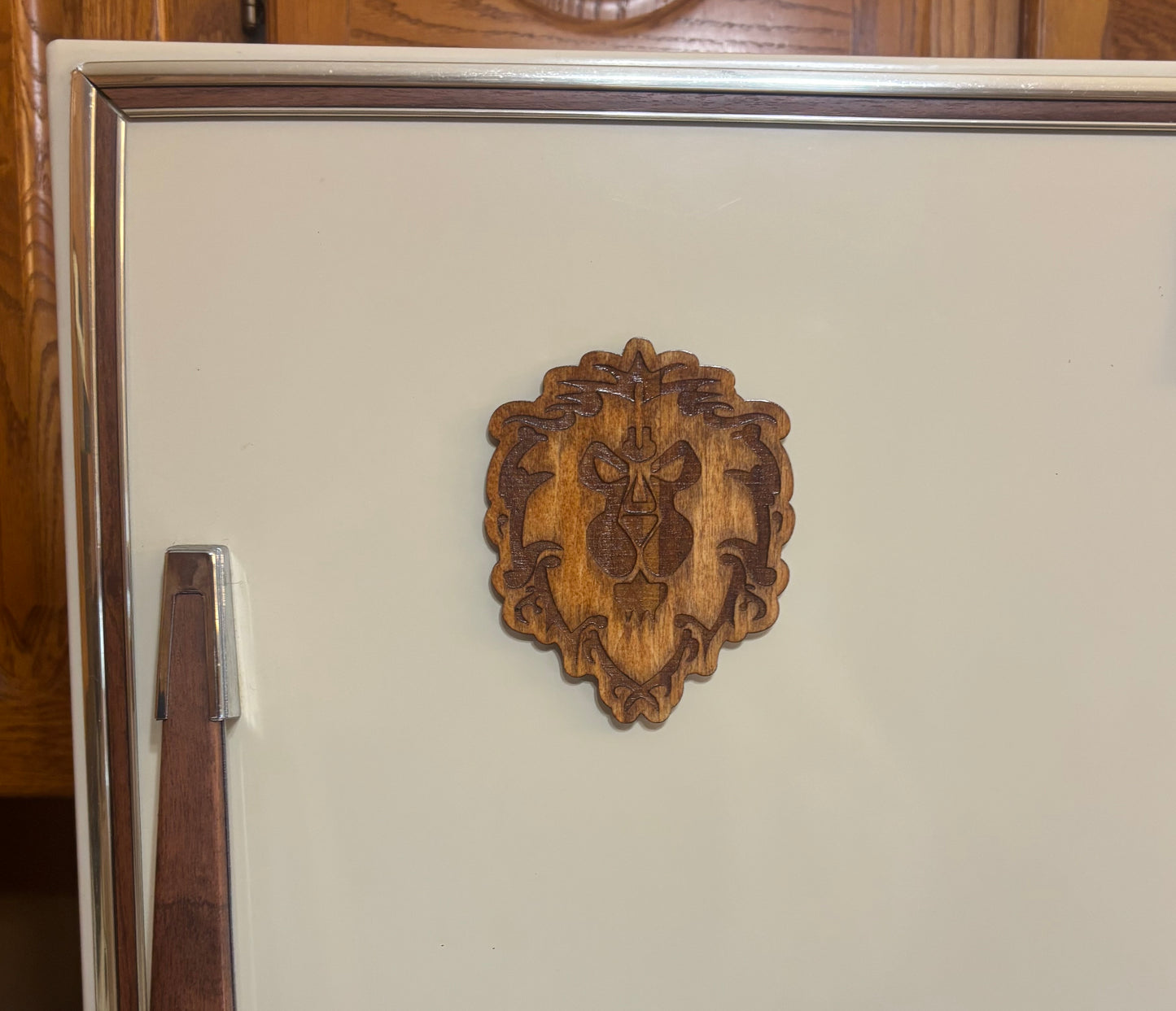 Stained basswood fridge magnet of a the Alliance symbol from the Warcraft video games