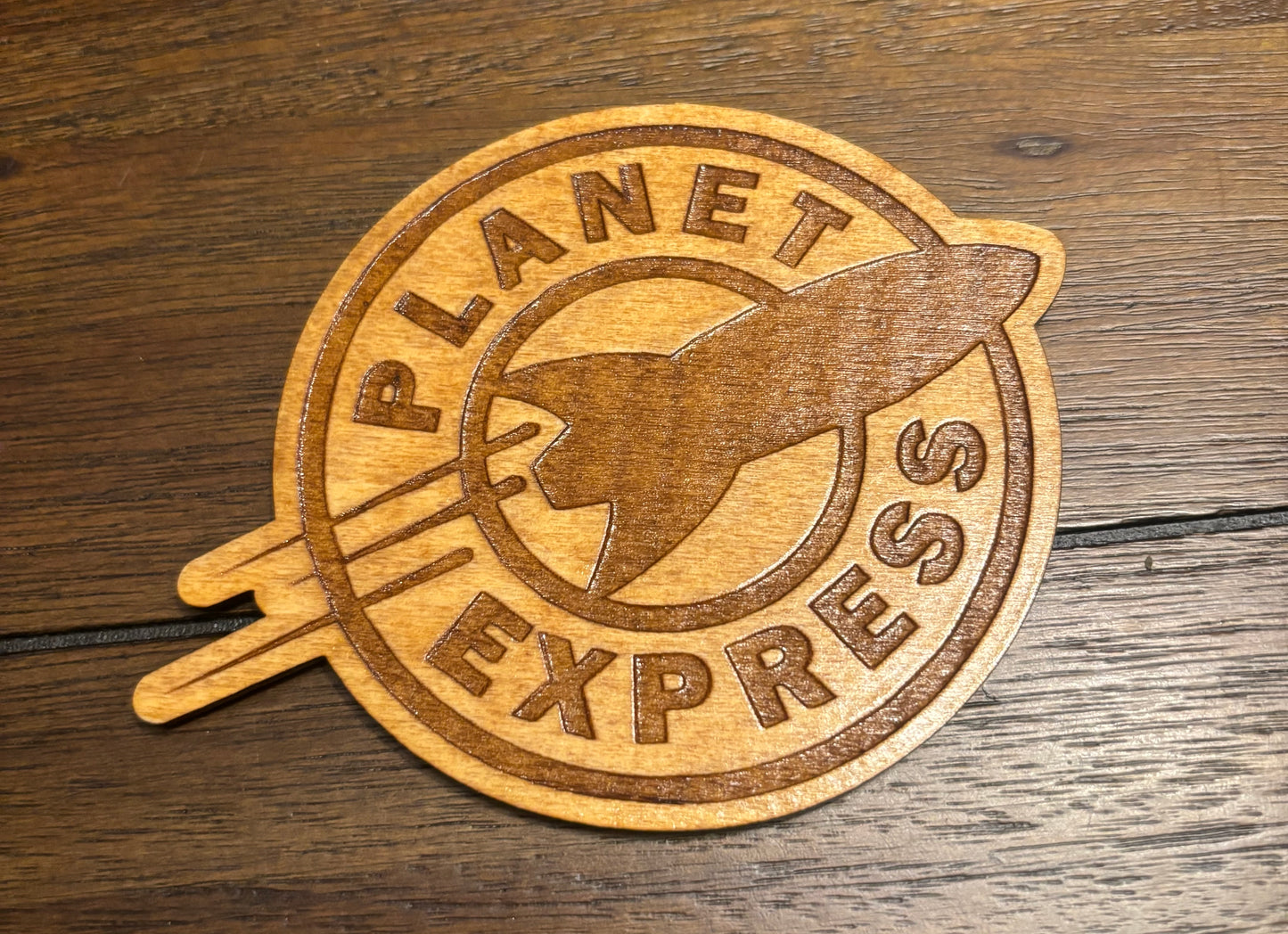 Stained basswood fridge magnet of the Planet Express logo from Futurama