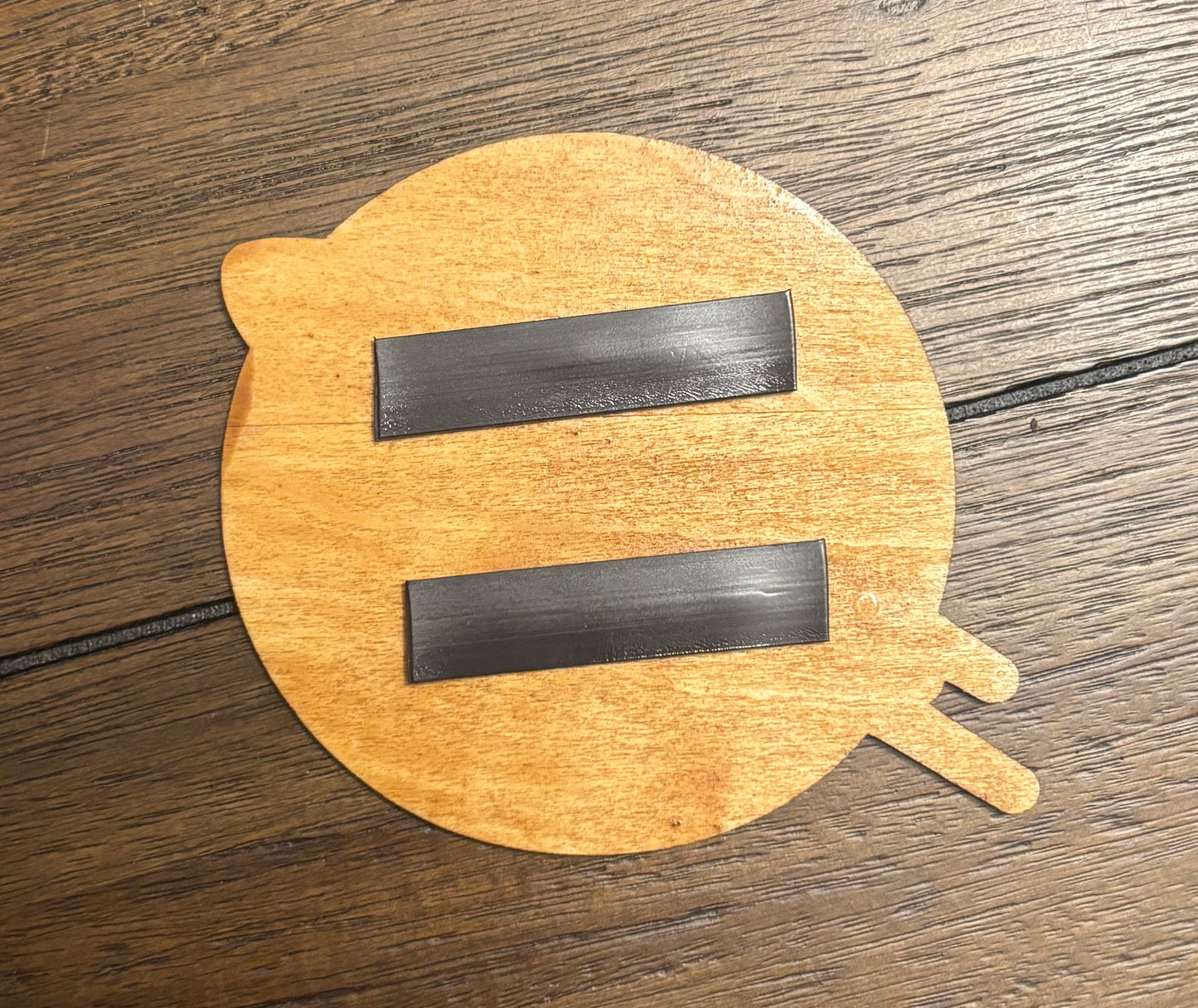Stained basswood fridge magnet of the Planet Express logo from Futurama