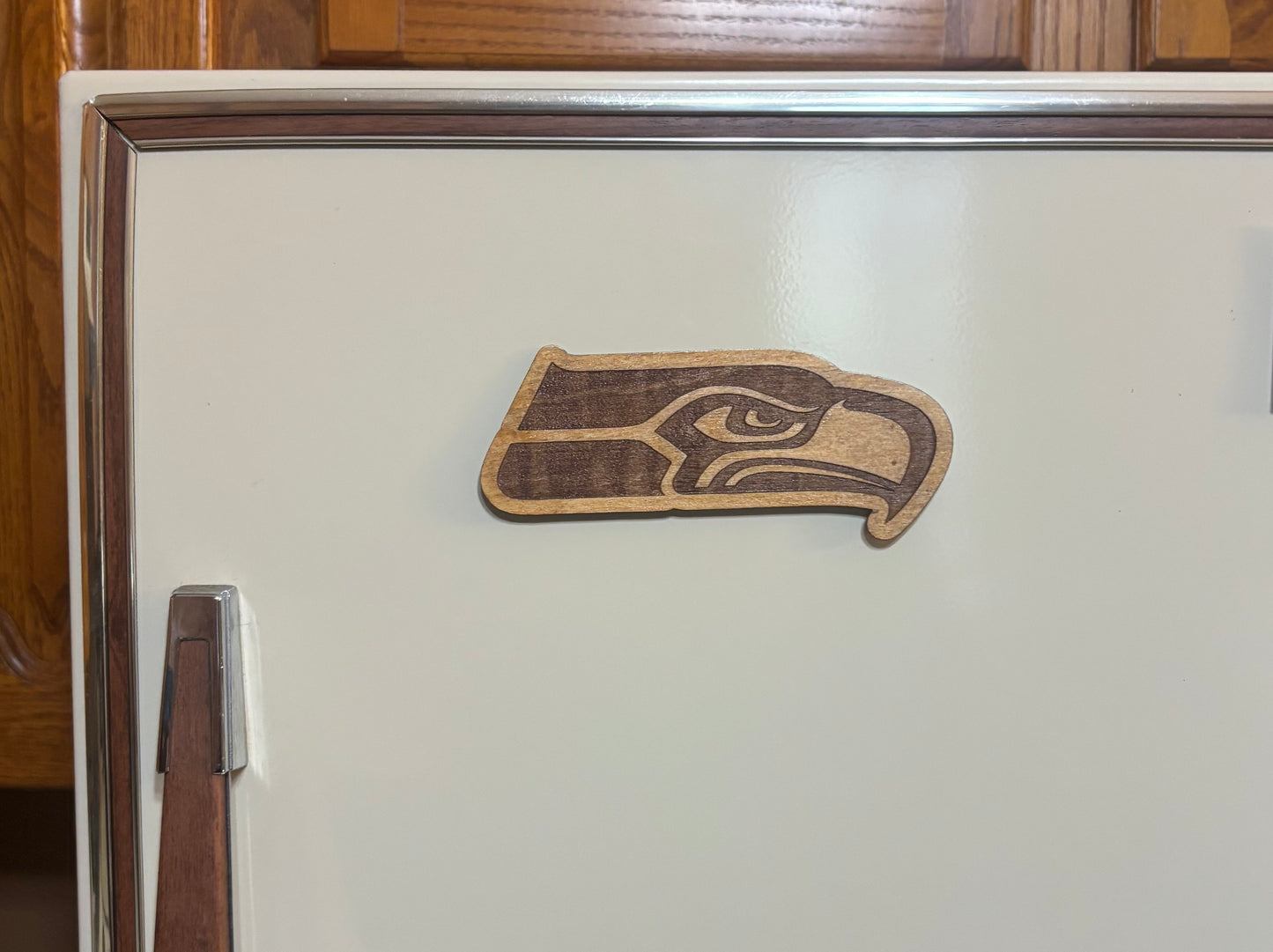 Stained basswood fridge magnet of the Seattle Seahawks football team logo