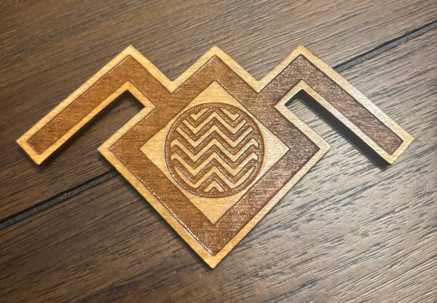 Stained basswood fridge magnet of the owl symbol from Twin Peaks