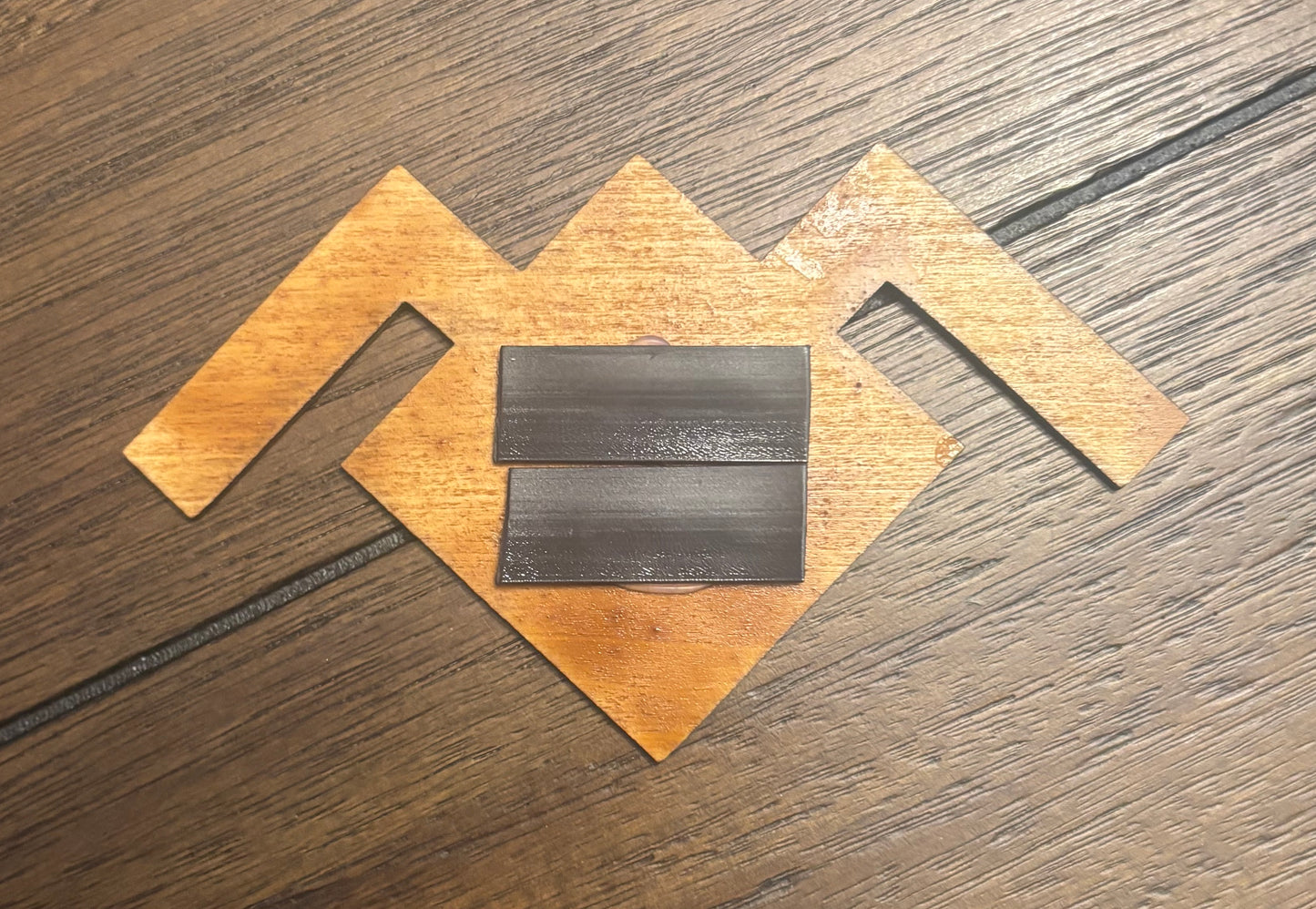 Stained basswood fridge magnet of the owl symbol from Twin Peaks