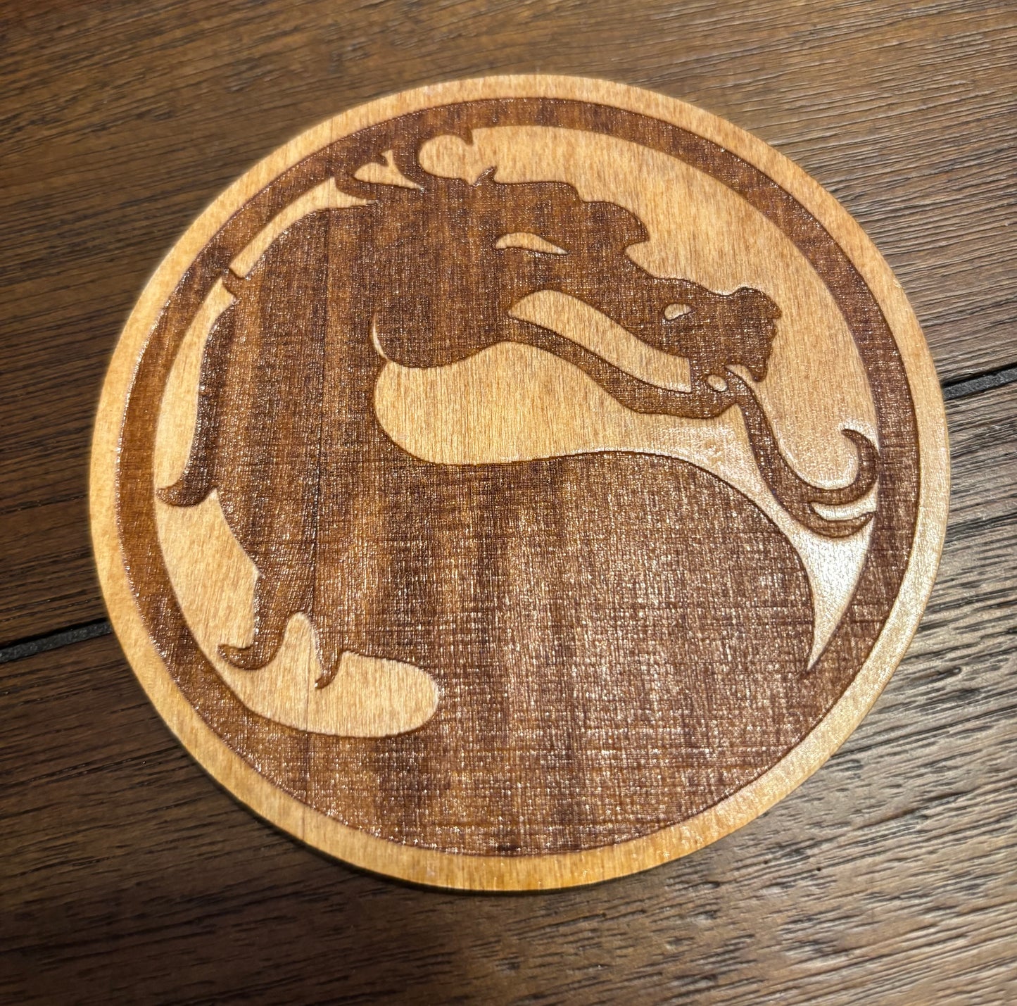 Stained basswood fridge magnet of Mortal Kombat logo