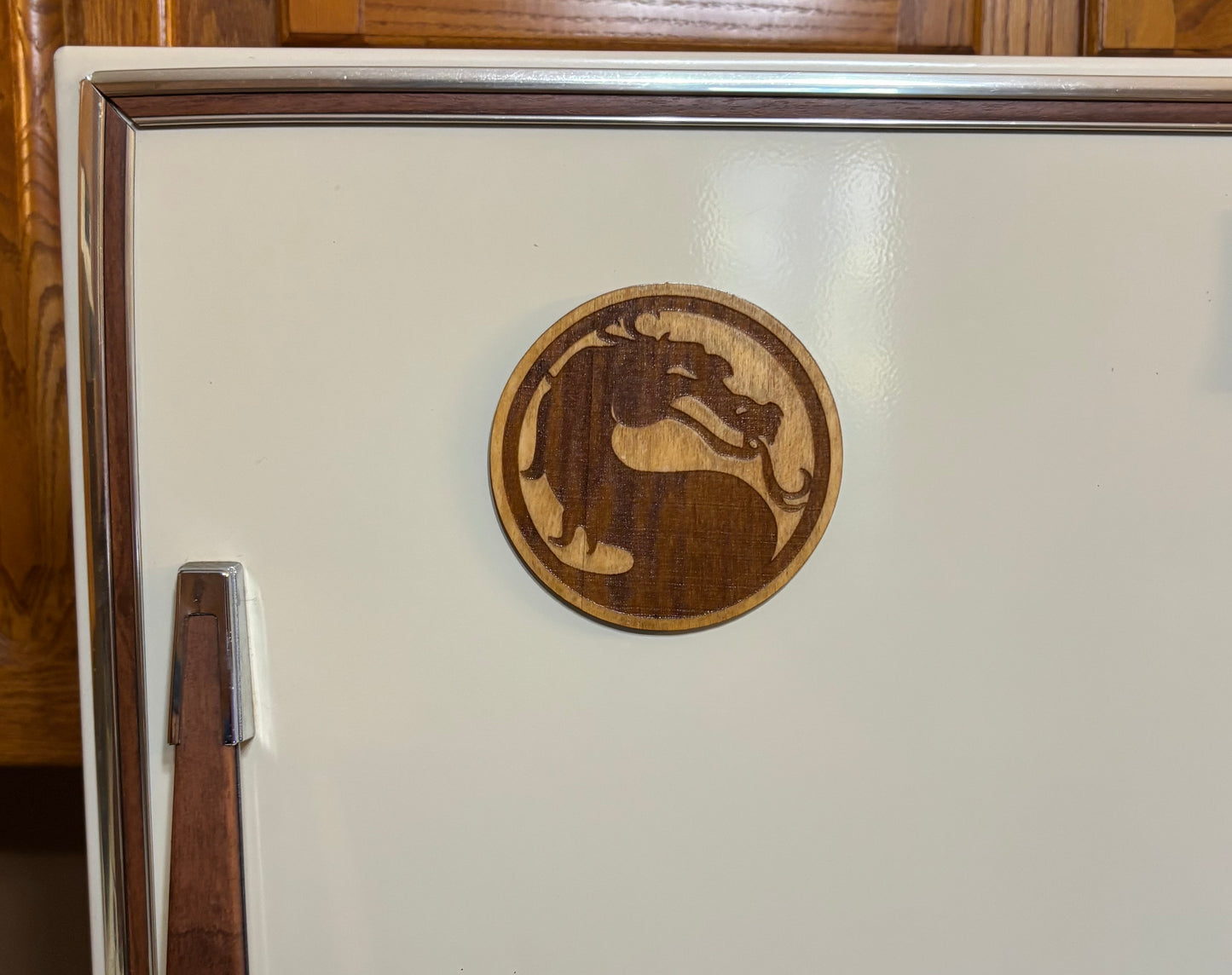 Stained basswood fridge magnet of Mortal Kombat logo