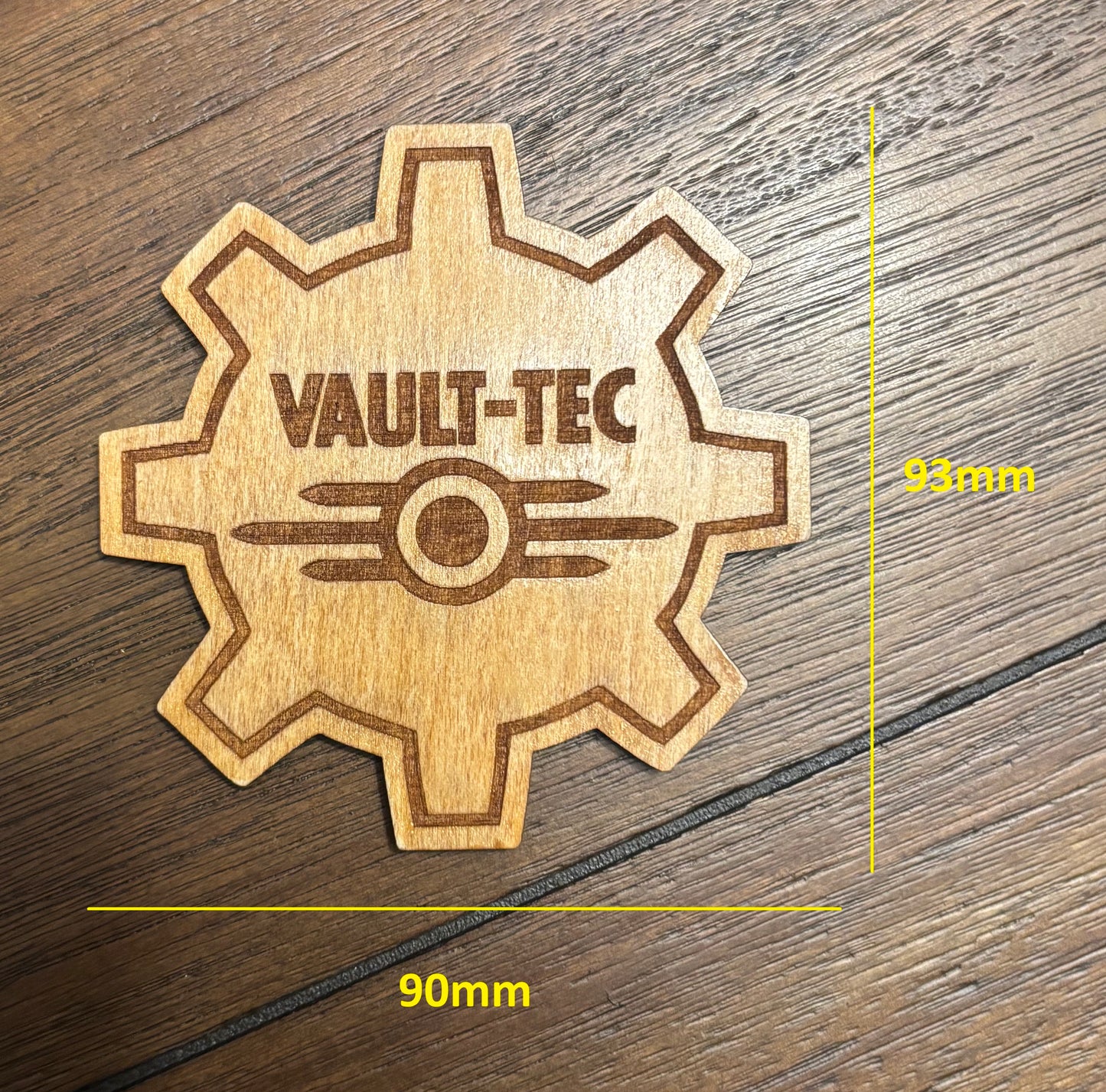 Stained basswood fridge magnet of the Vault-Tec logo from the Fallout video games