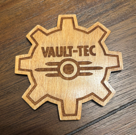 Stained basswood fridge magnet of the Vault-Tec logo from the Fallout video games