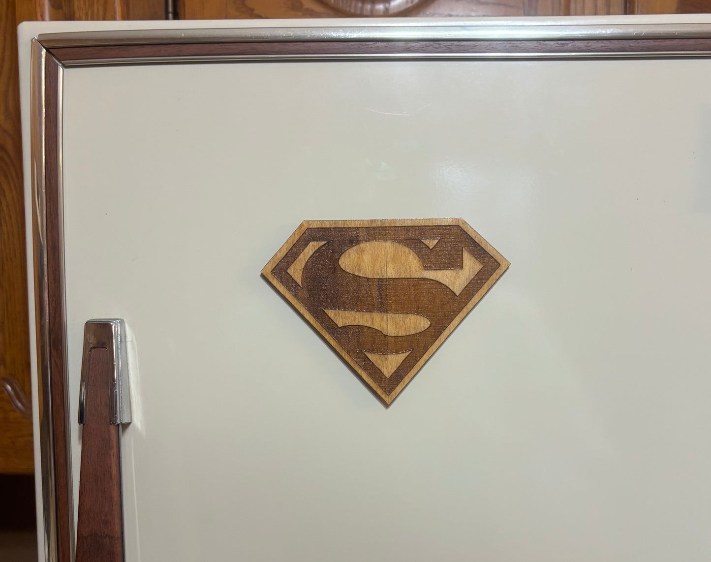 Stained basswood fridge magnet of the Superman logo
