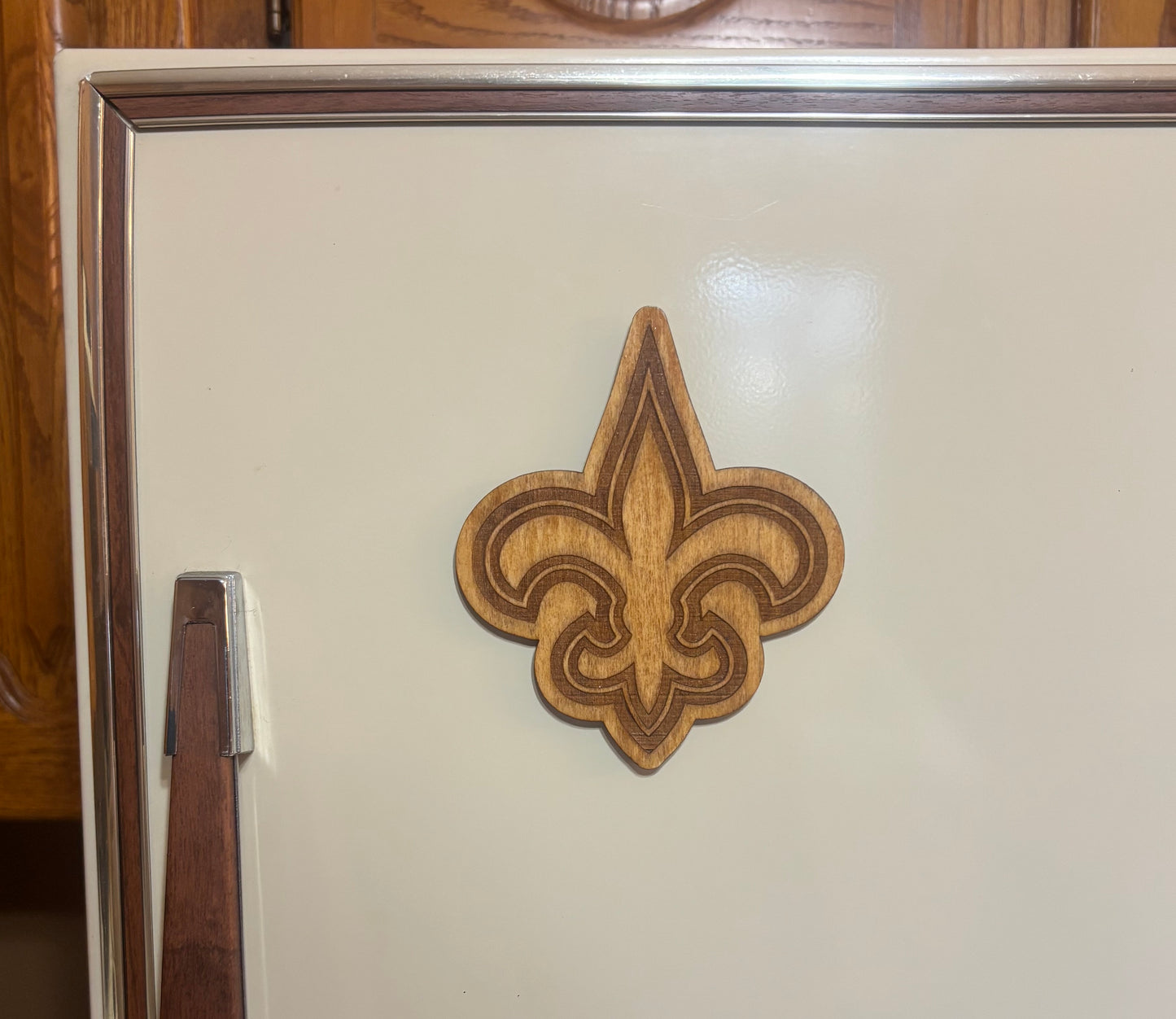 Stained basswood fridge magnet of the New Orleans Saints football team logo