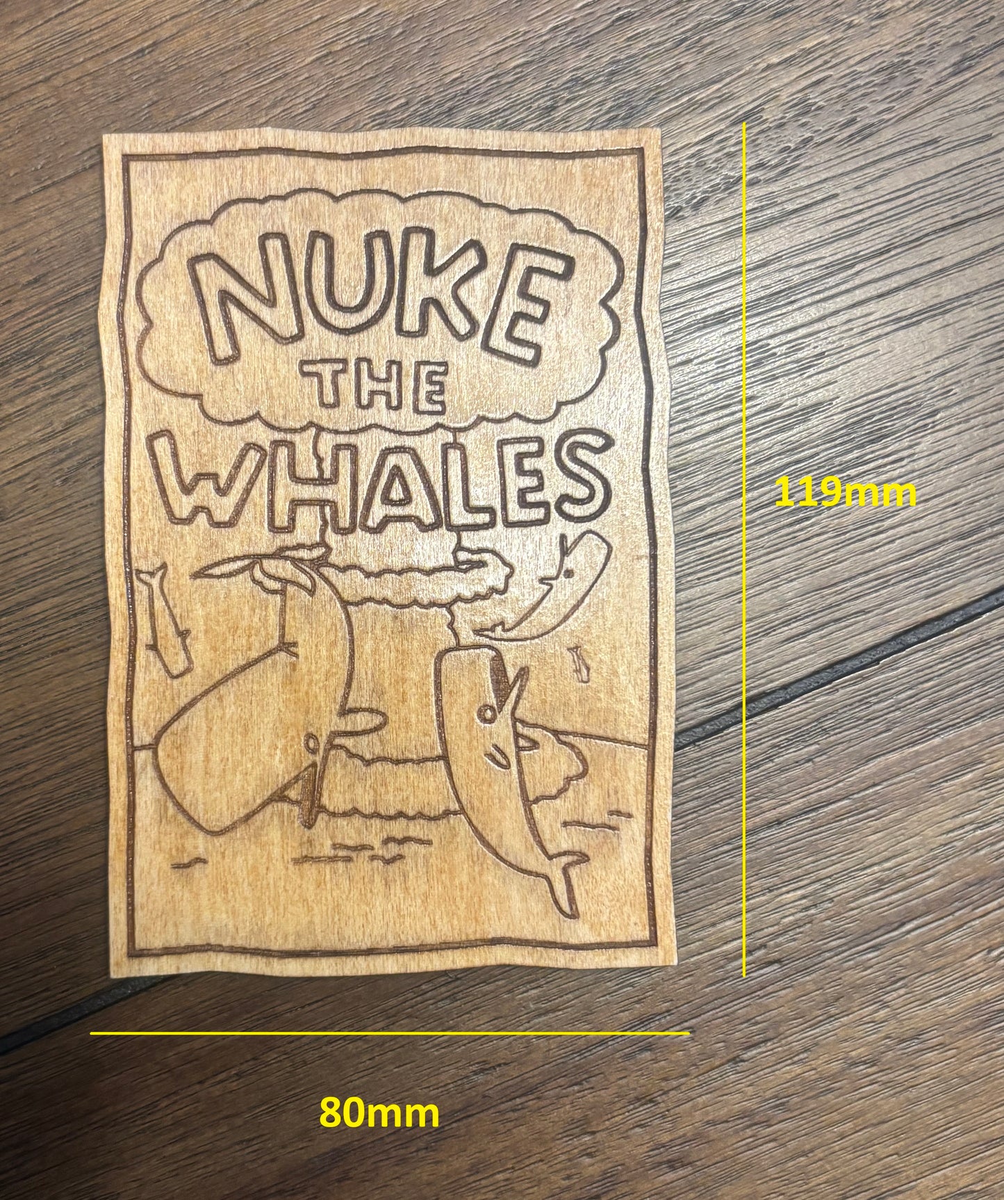 Stained basswood fridge magnet of Nelson's Nuke the Whales poster from the Simpsons