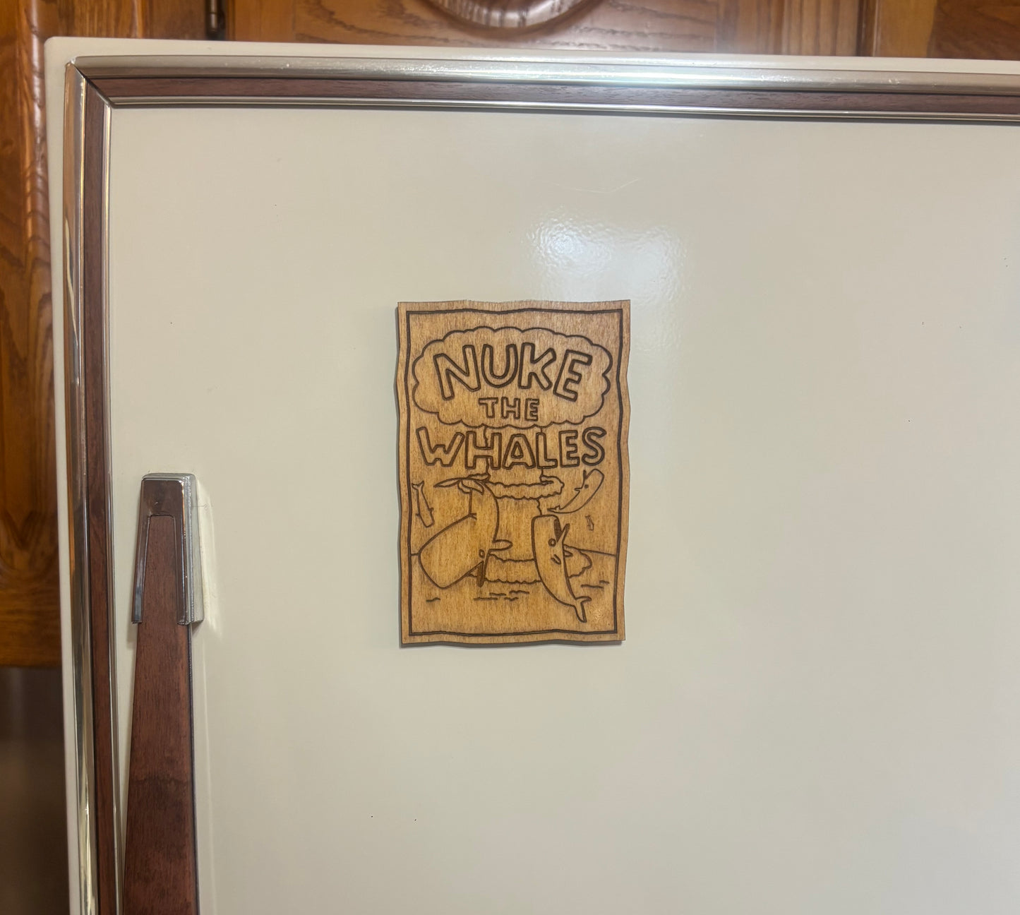 Stained basswood fridge magnet of Nelson's Nuke the Whales poster from the Simpsons