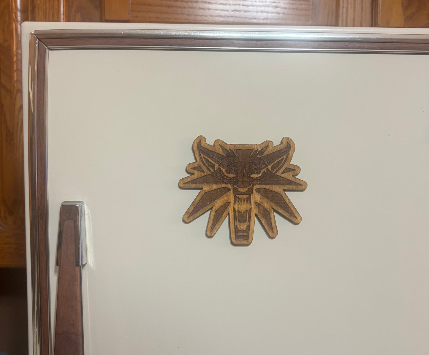 Stained basswood fridge magnet of the Witcher logo