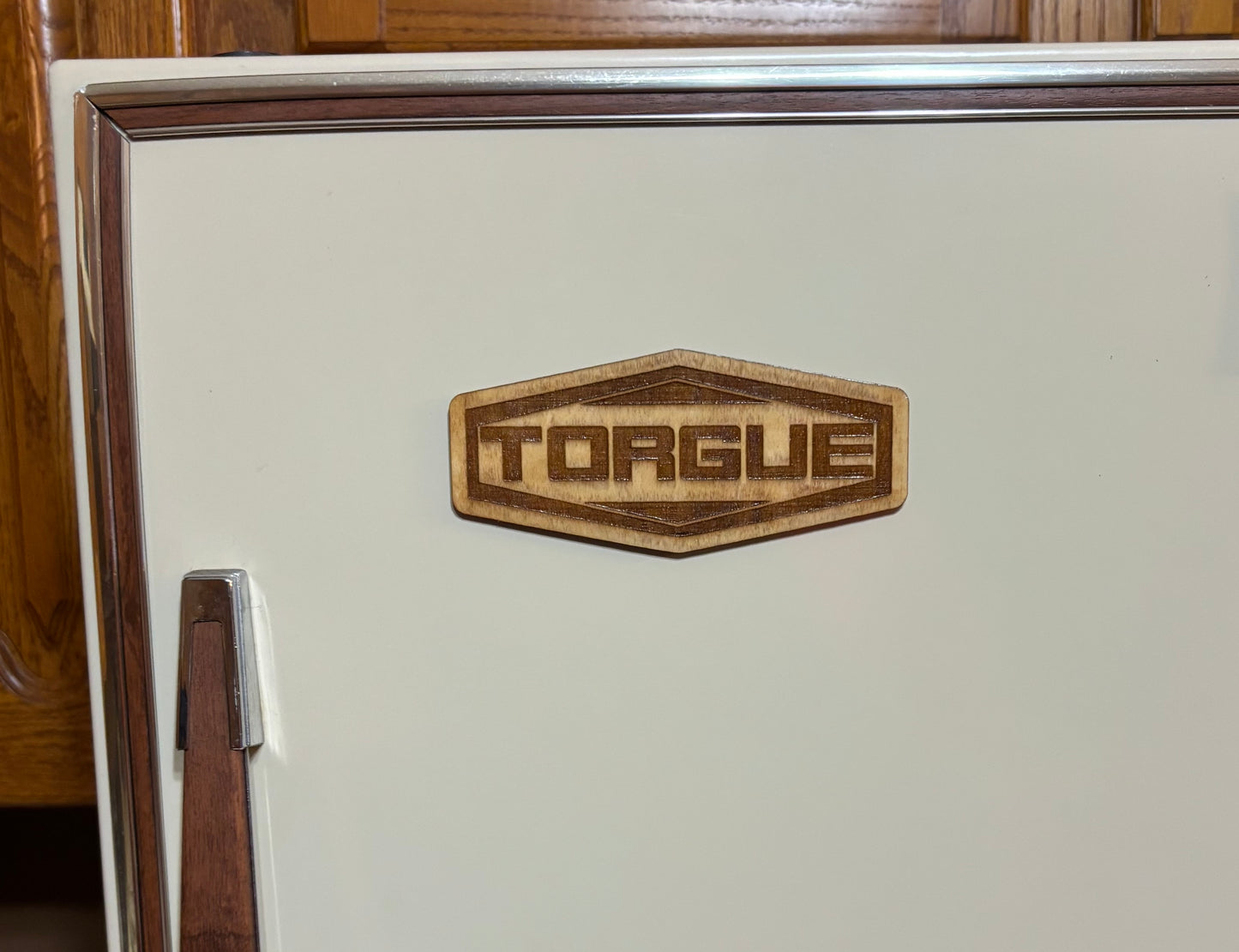 Stained basswood fridge magnet of the Torgue logo from the Borderlands video games